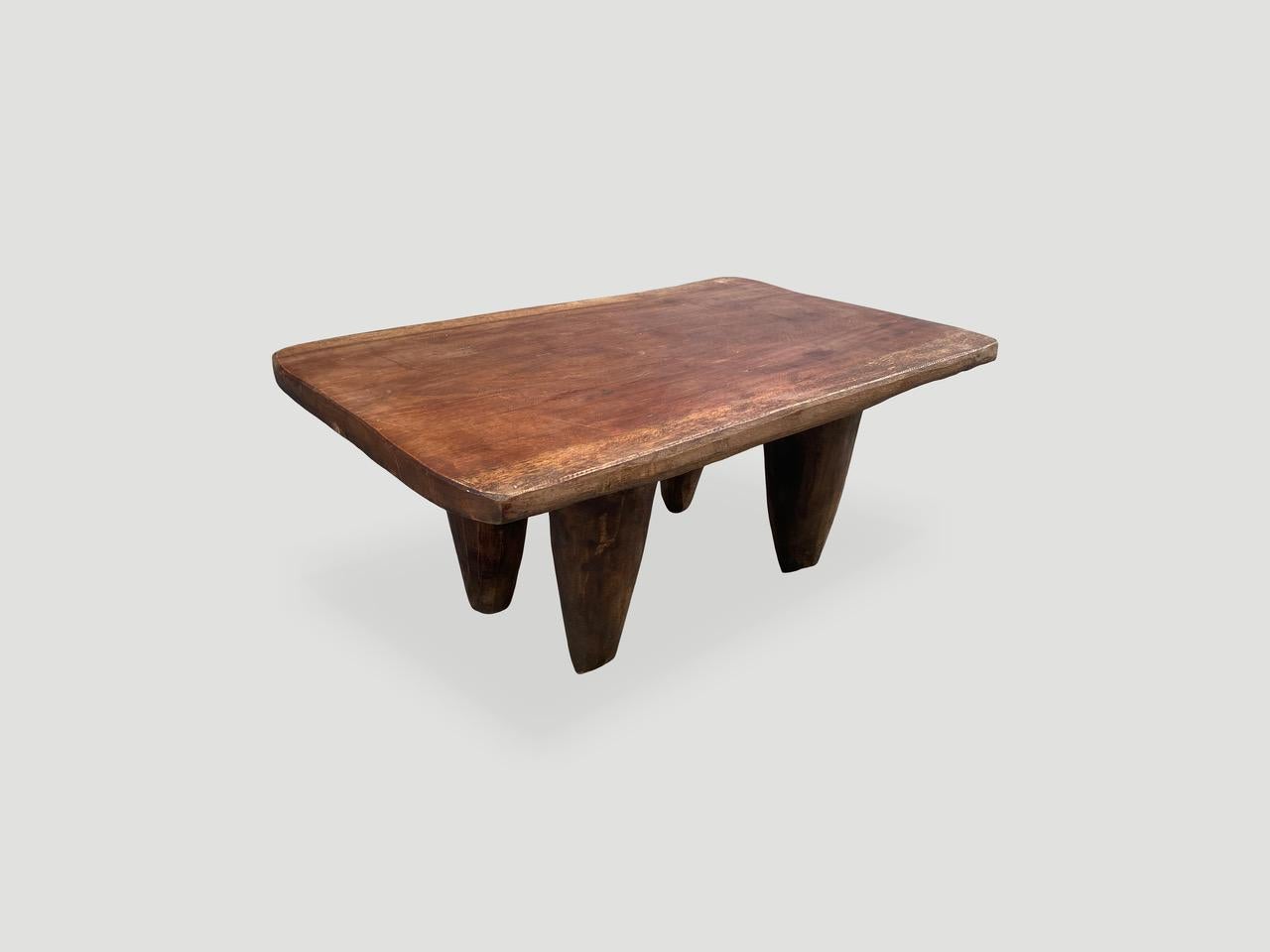Antique coffee table, bench or side table, hand carved by the Senufo tribes from a single block of iroko wood, native to the west coast of Africa. The wood is tough, dense and very durable. Shown with cone style legs. This smaller size is rare.