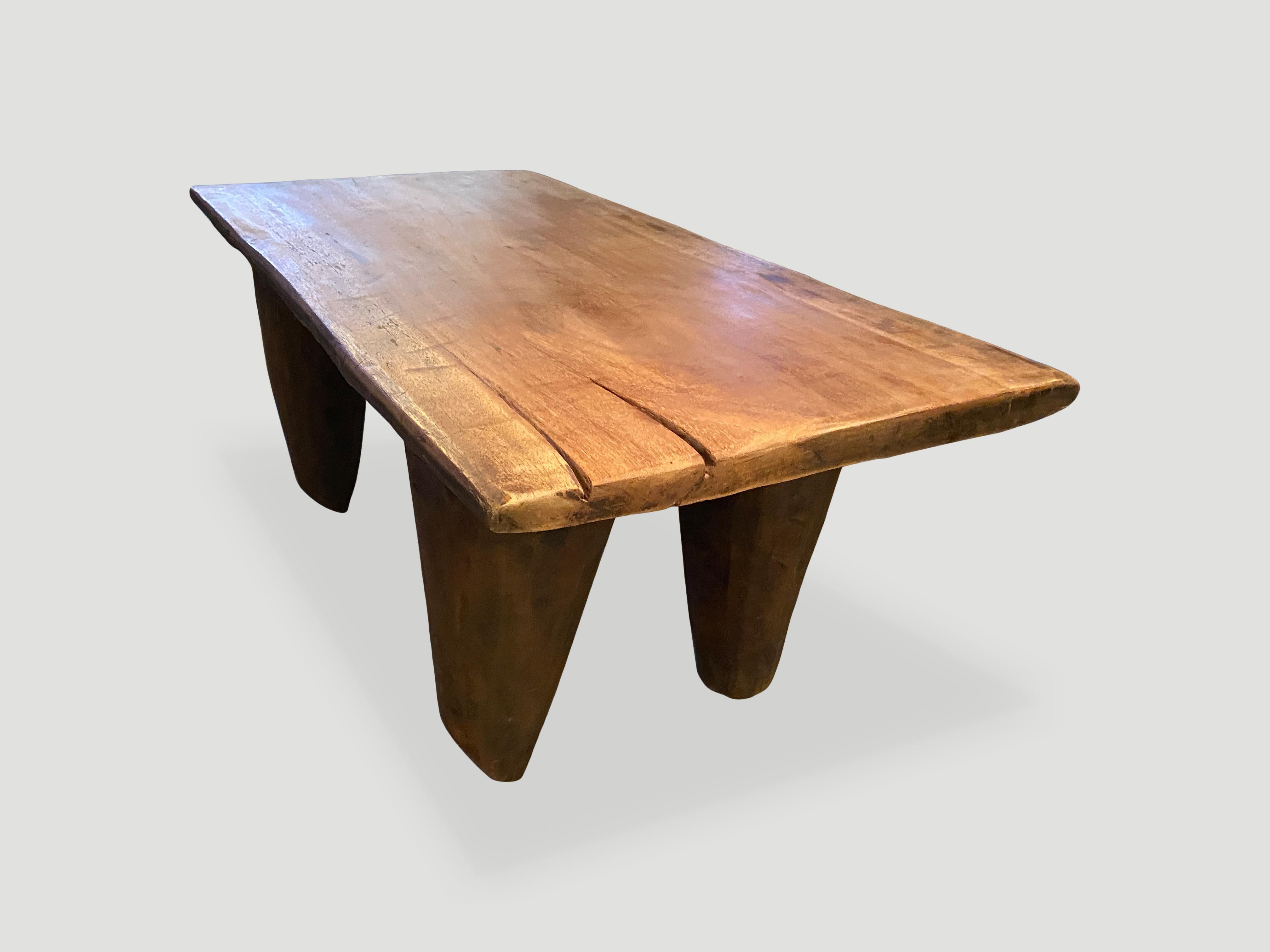 Antique coffee table hand carved by the Senufo tribes from a single block of iroko wood, native to the west coast of Africa. The wood is tough, dense and very durable. Shown with cone style legs. We only source the best. 

This bench or coffee