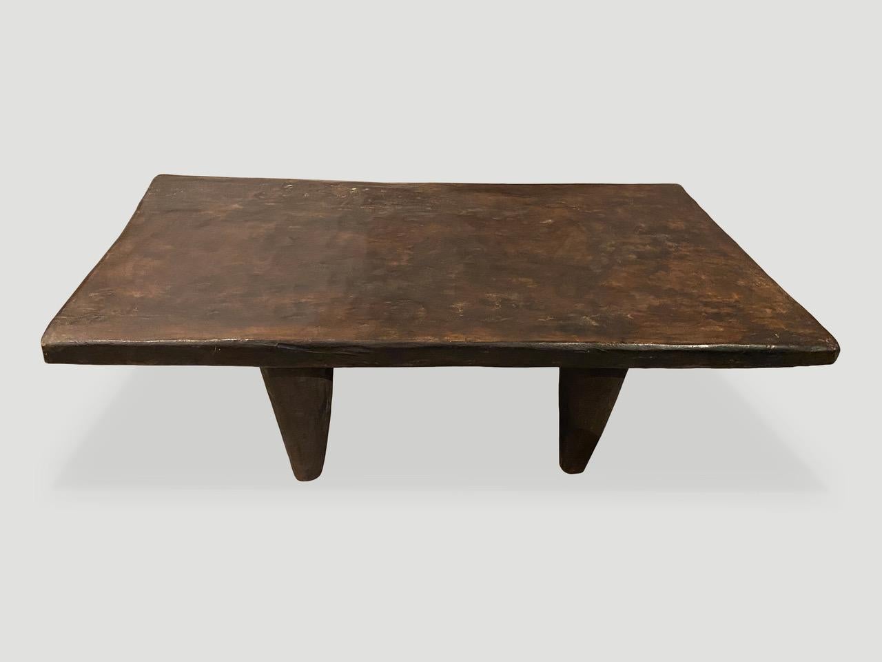 Antique coffee table hand carved by the Senufo tribes from a single block of Iroko wood, native to the west coast of Africa. The wood is tough, dense and very durable. Shown with cone style legs. We only source the best. This one is beautiful and