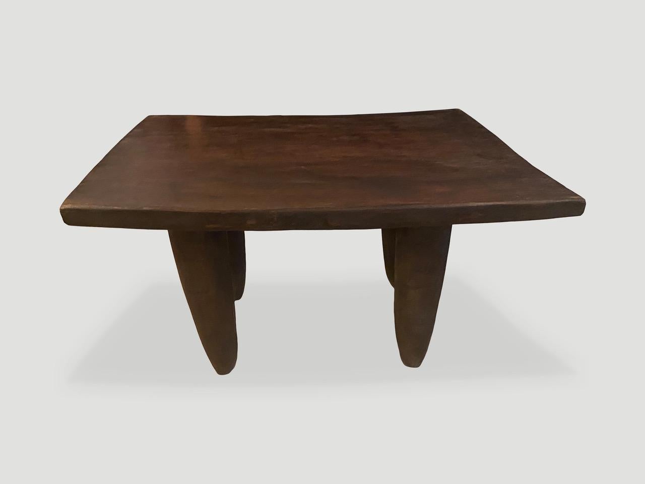 Antique coffee table hand carved by the Senufo tribes from a single block of Iroko wood, native to the west coast of Africa. The wood is tough, dense and very durable. Shown with cone style legs. We only source the best. This one is beautiful, wider