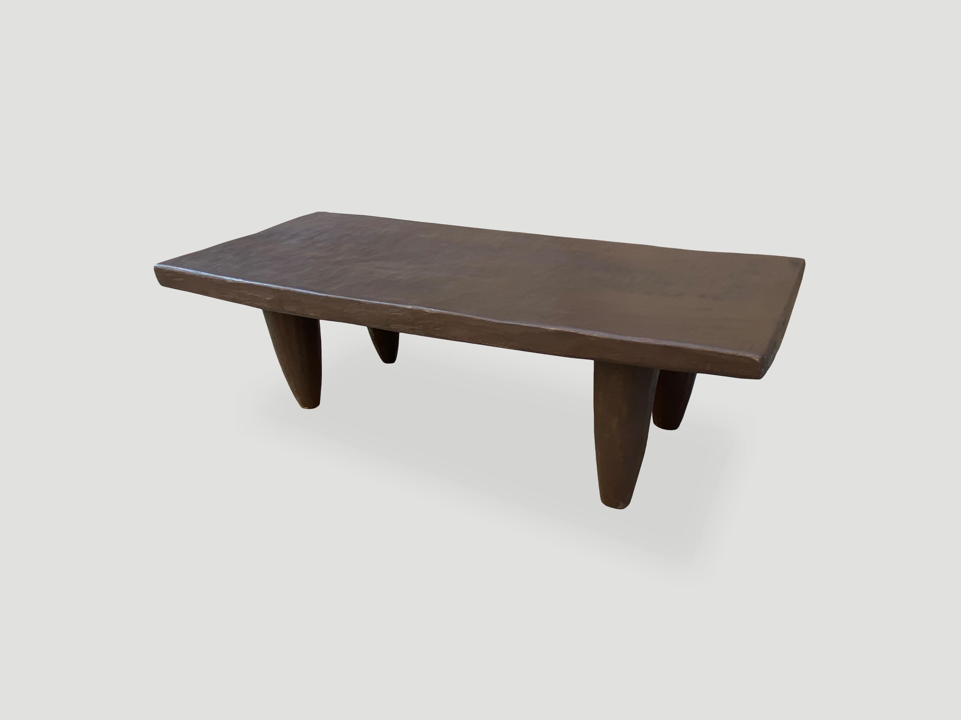 Antique coffee table or bench hand carved by the Senufo tribes from a single block of iroko wood, native to the west coast of Africa. The wood is tough, dense and very durable. Shown with cone style legs. We only source the best. 

This bench or