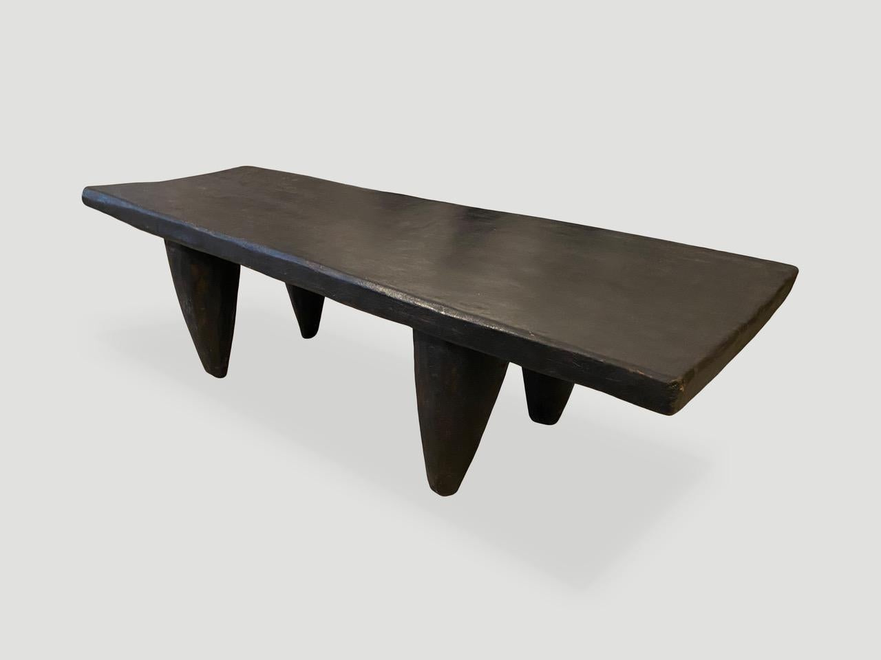 Antique coffee table or bench hand carved by the Senufo tribes from a single block of iroko wood, native to the west coast of Africa. The wood is tough, dense and very durable. Shown with cone style legs. We only source the best. 

This bench or