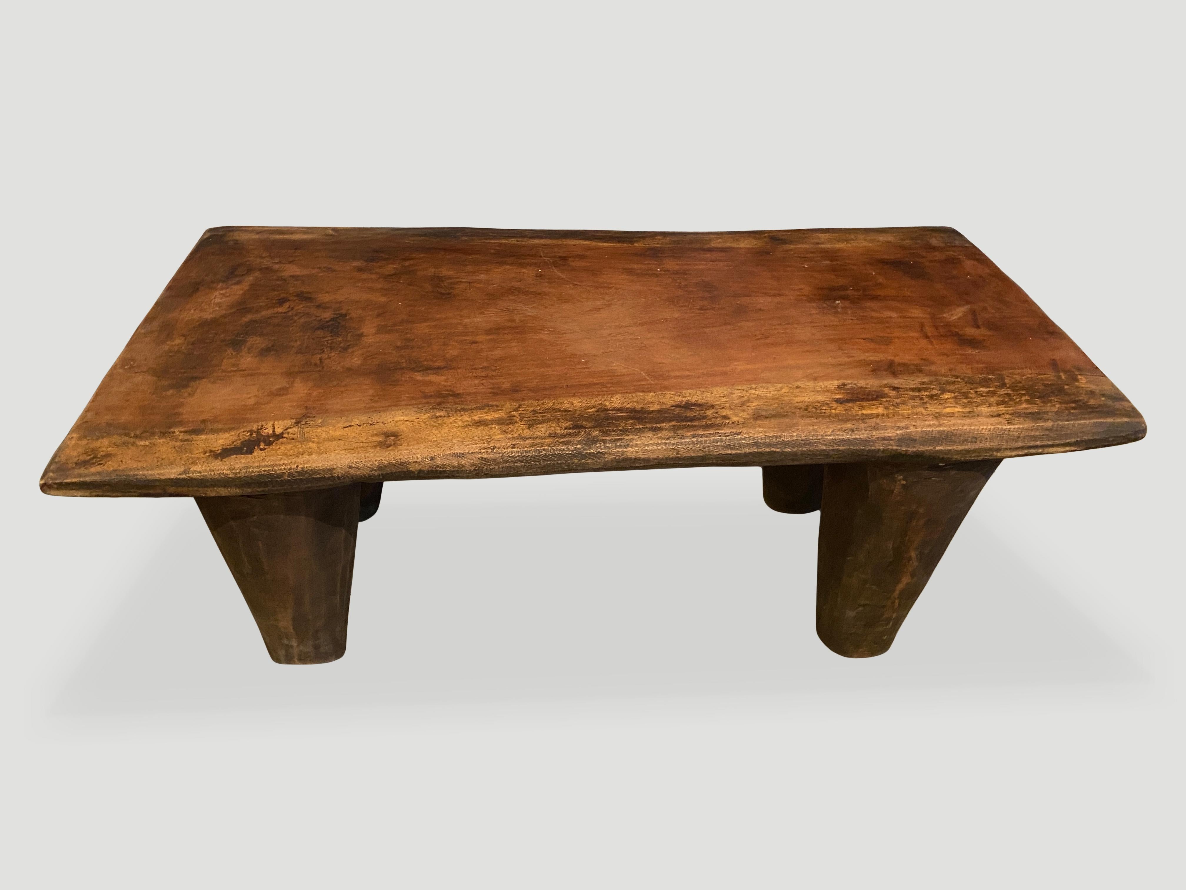 Antique coffee table or bench hand carved by the Senufo tribes from a single block of iroko wood, native to the west coast of Africa. The wood is tough, dense and very durable. Shown with cone style legs. We only source the best. 

This bench or