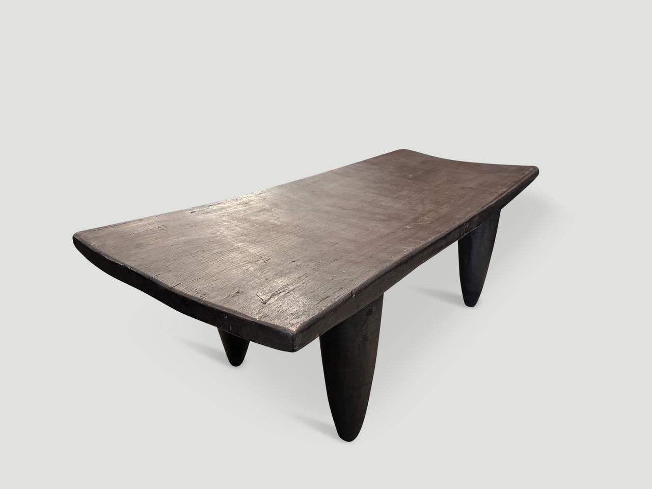 Antique coffee table hand carved by the Senufo tribes from a single block of Iroko wood, native to the west coast of Africa. The wood is tough, dense and very durable. Shown with cone style legs. We only source the best. 

This beautiful coffee
