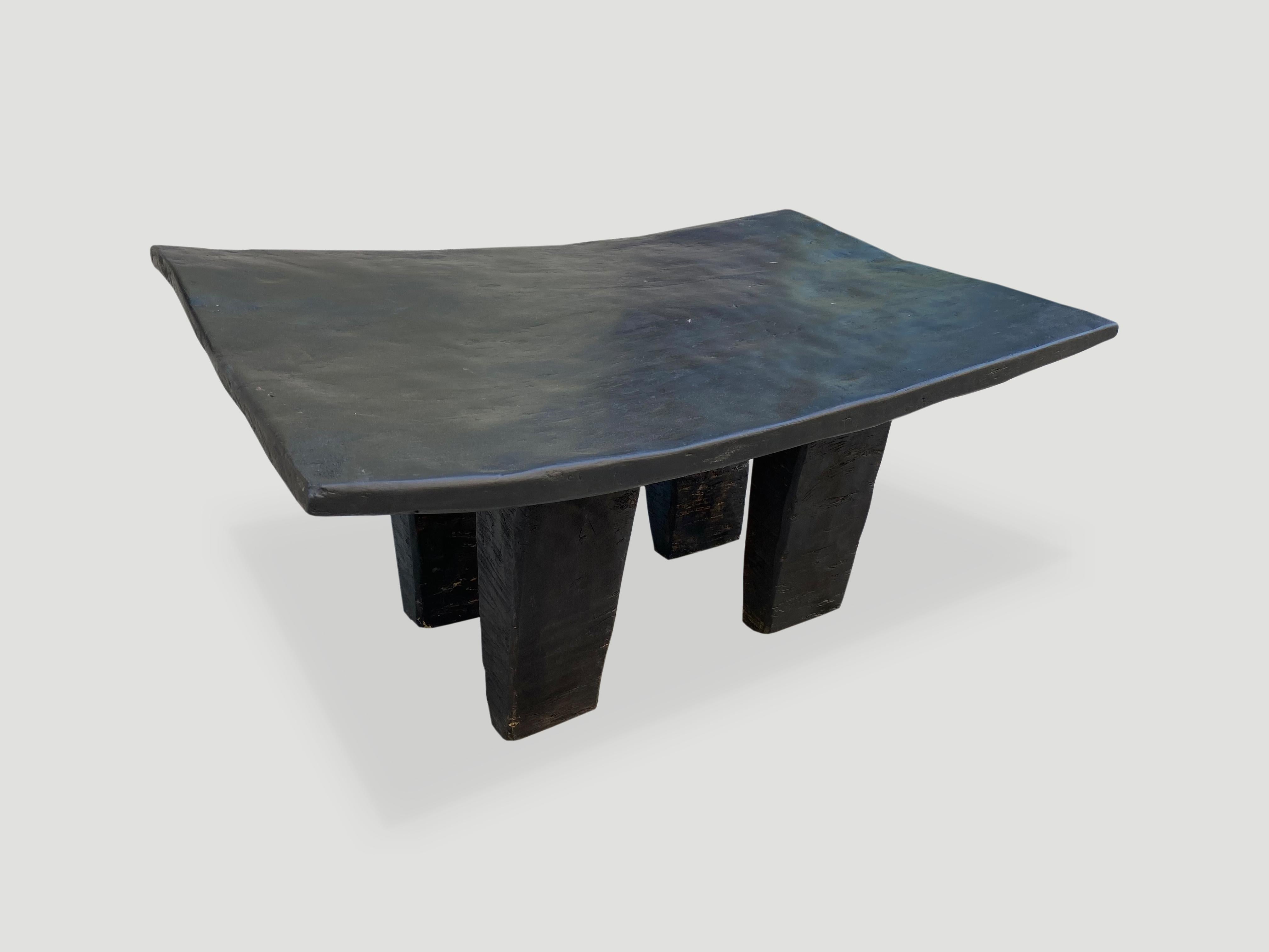 Antique coffee table hand carved by the Senufo tribes from a single block of iroko wood, native to the west coast of Africa. The wood is tough, dense and very durable. We stained the wood espresso. Shown with unusual rectangular style legs. We only