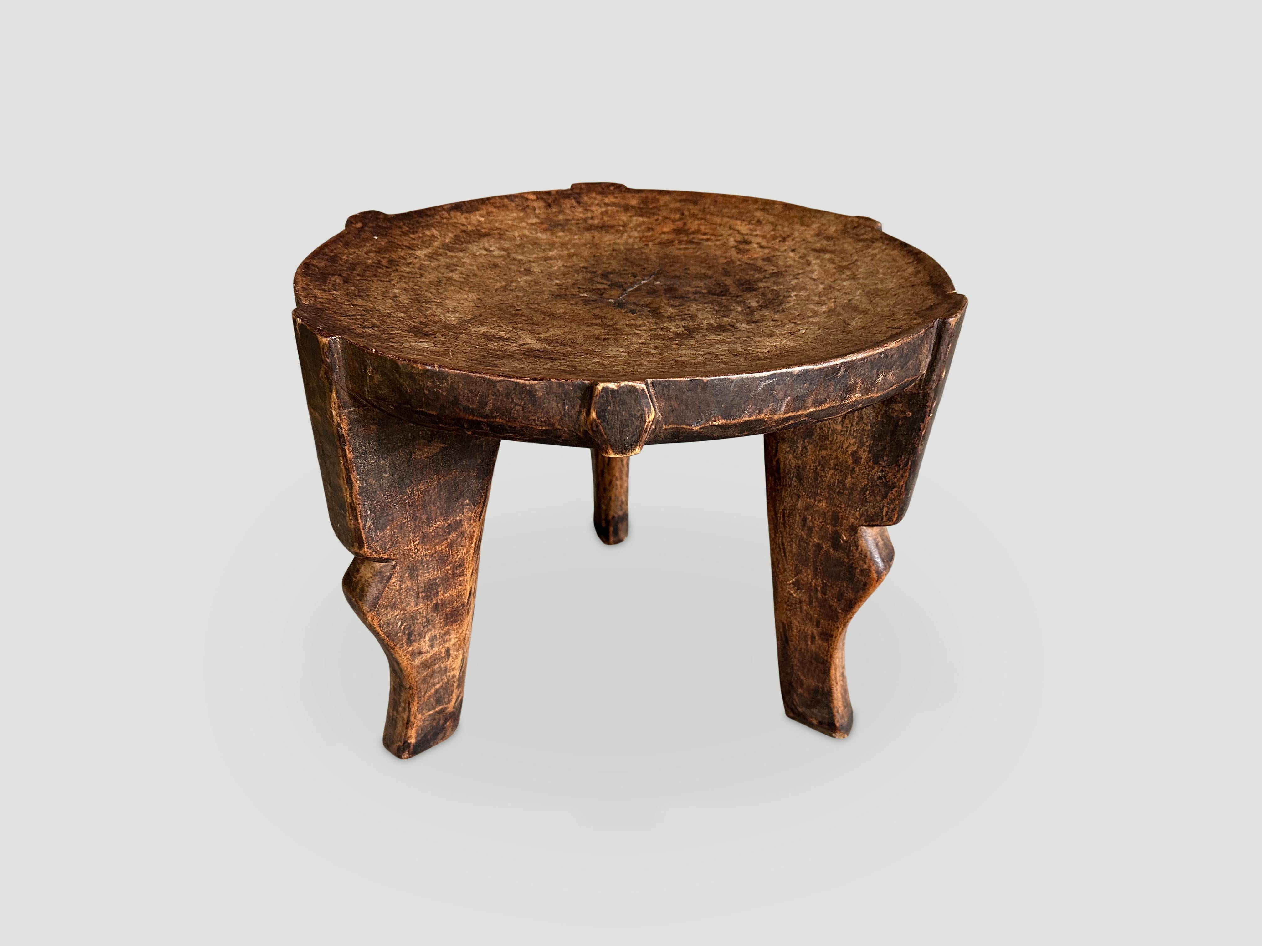 Beautiful patina on this rare African side table hand carved from a single block of wood. We only source the best. This one is stunning. circa 1900. Pair available. The price and size reflects the one shown.

This side table was sourced in the