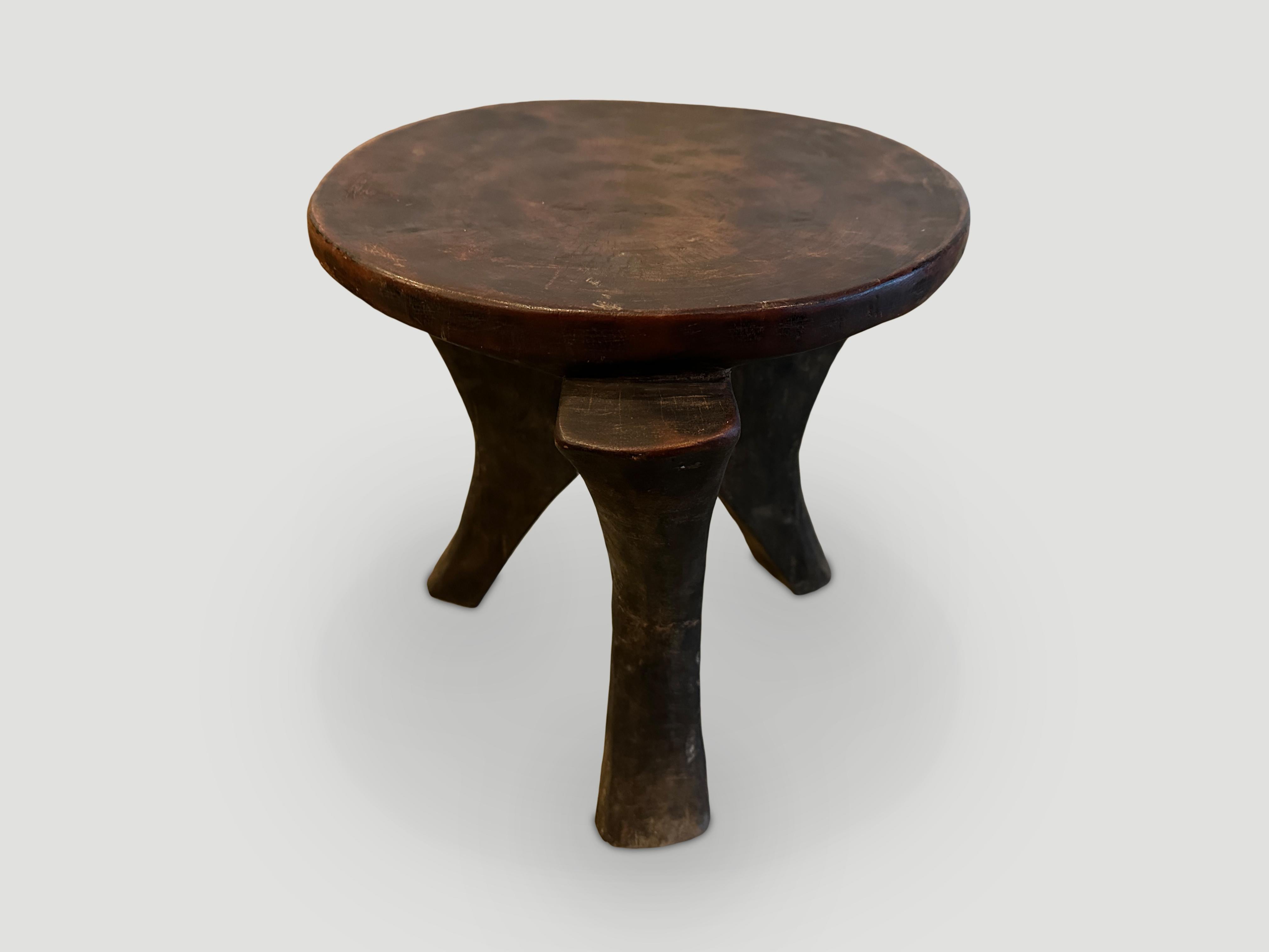 Beautiful African side table with lovely patina. The entire piece is hand carved out of a single block of mahogany wood. We only source the best. 

This side table was sourced in the spirit of Wabi Sabi, a Japanese philosophy that beauty can be