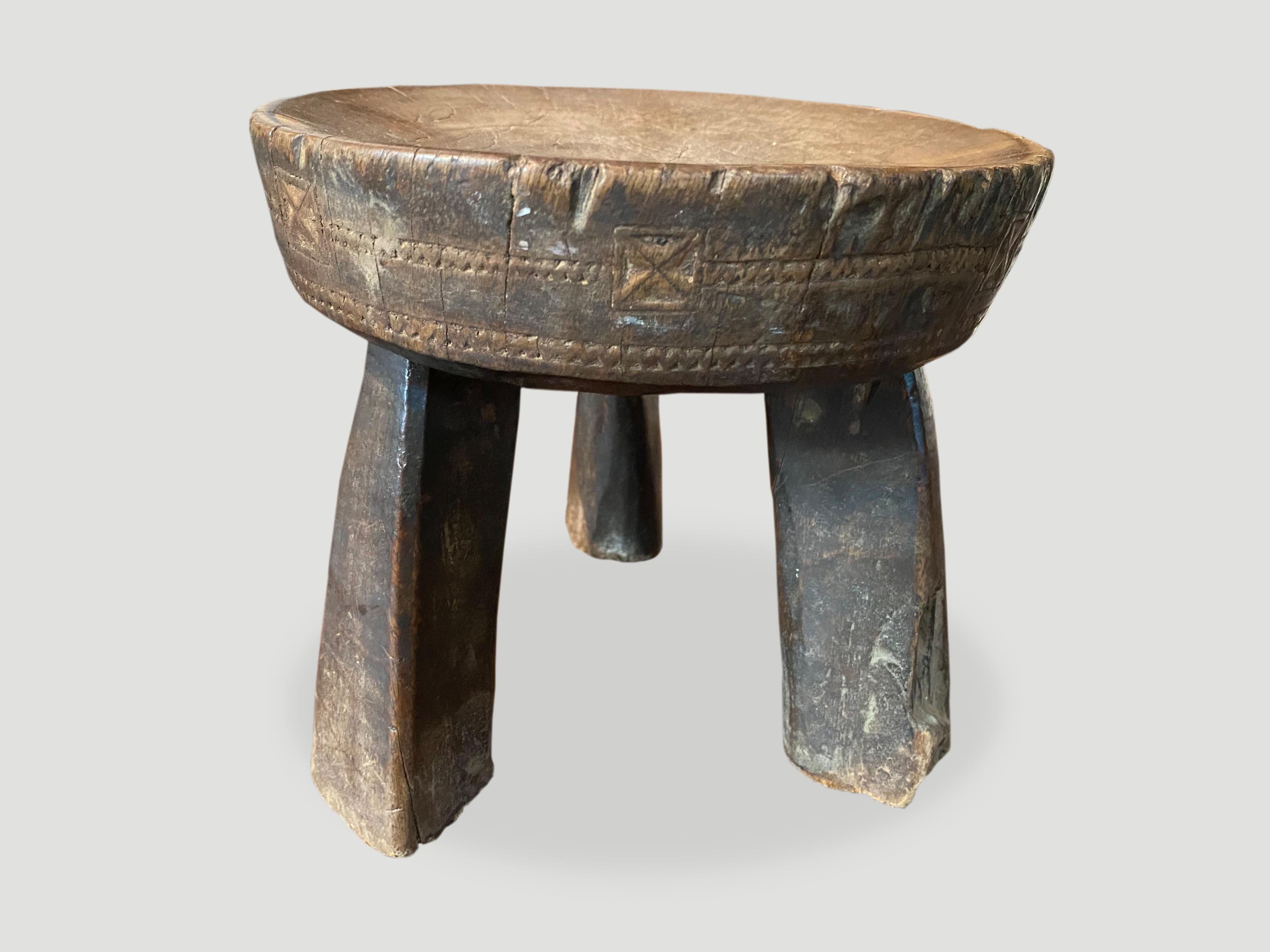 Beautiful hand carved African teak stool or side table with lovely patina and carvings. The entire piece is hand carved out of a single piece of wood.

This stool or side table was sourced in the spirit of wabi-sabi, a Japanese philosophy that