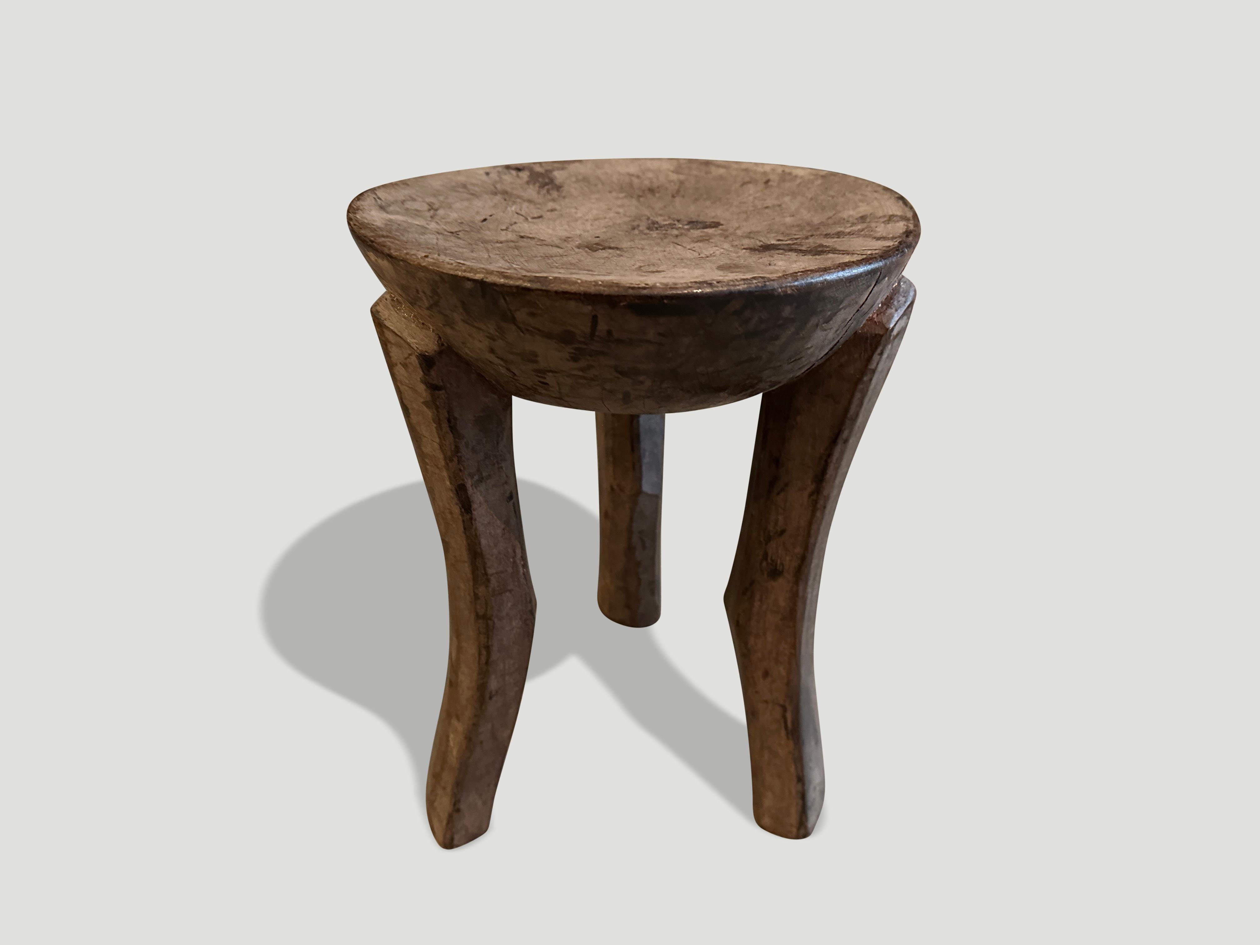 Antique African side table hand carved from a single block of wood. 

This side table was sourced in the spirit of Wabi-Sabi, a Japanese philosophy that beauty can be found in imperfection and impermanence. It is a beauty of things modest and