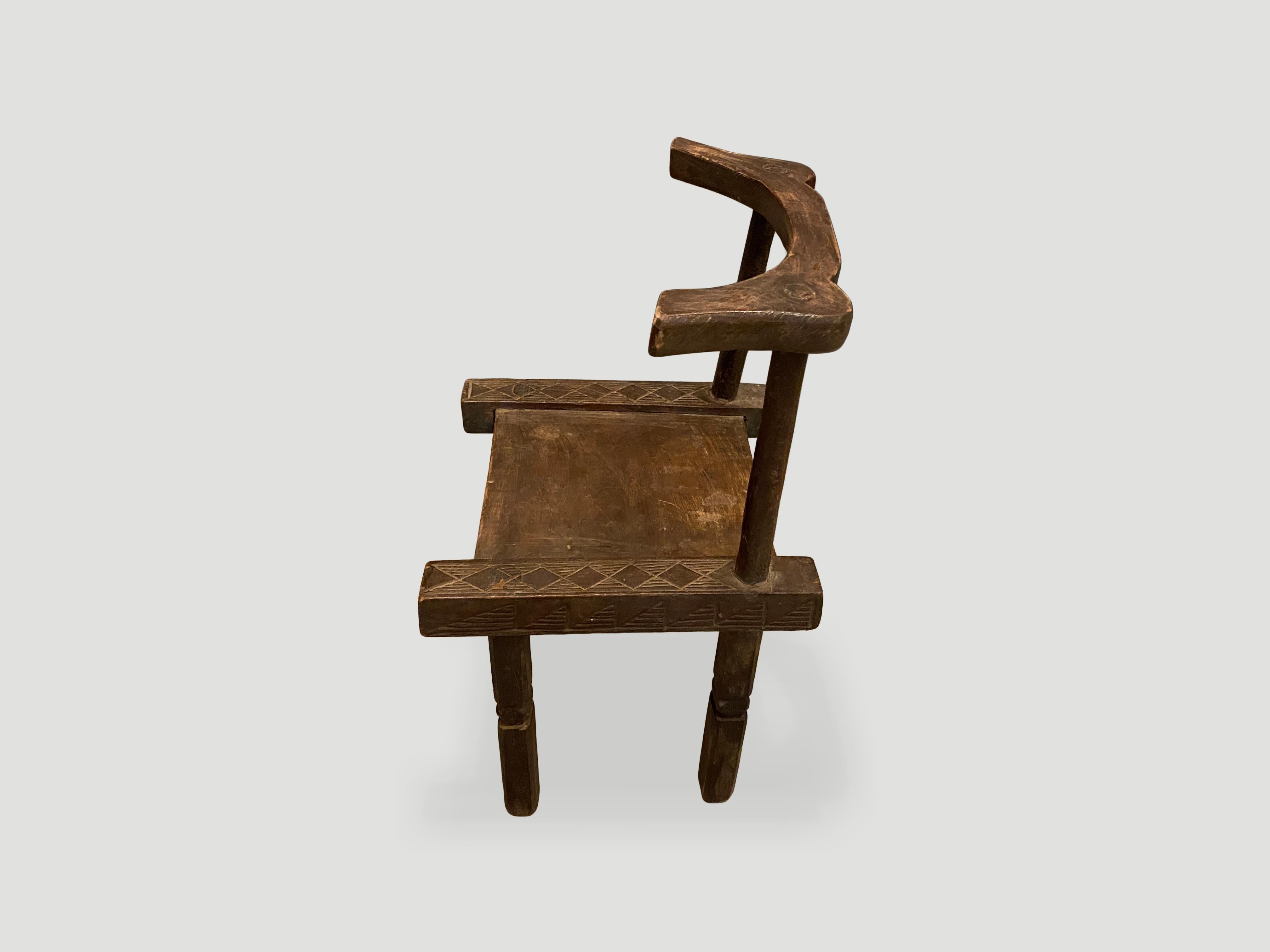 Hand carved wooden chair from the Ivory Coast of Africa. This can also be used as a low side table. A piece of art. 

This chair was sourced in the spirit of wabi-sabi, a Japanese philosophy that beauty can be found in imperfection and