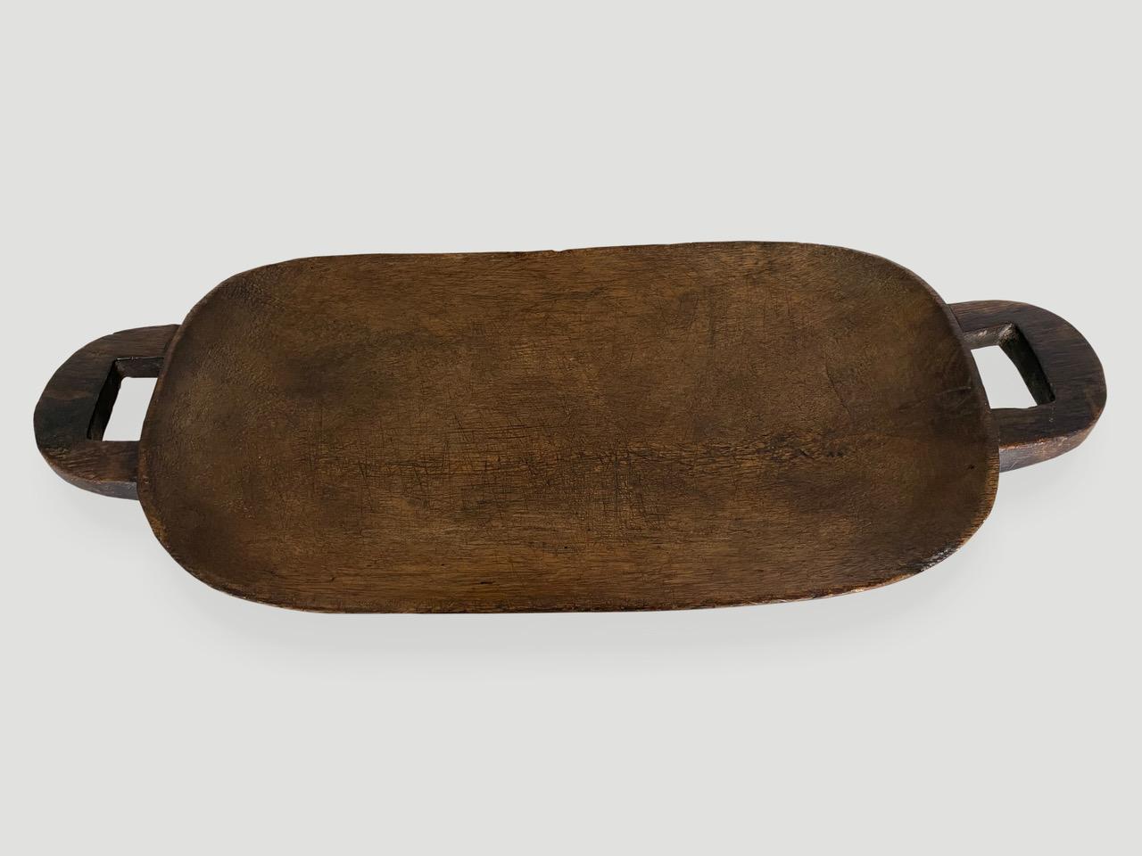 Beautiful patina on this fabulous African Zulu platter hand carved from a single block of wood. Stunning. Mid 20th C.

This wooden platter was sourced in the spirit of wabi-sabi, a Japanese philosophy that beauty can be found in imperfection and