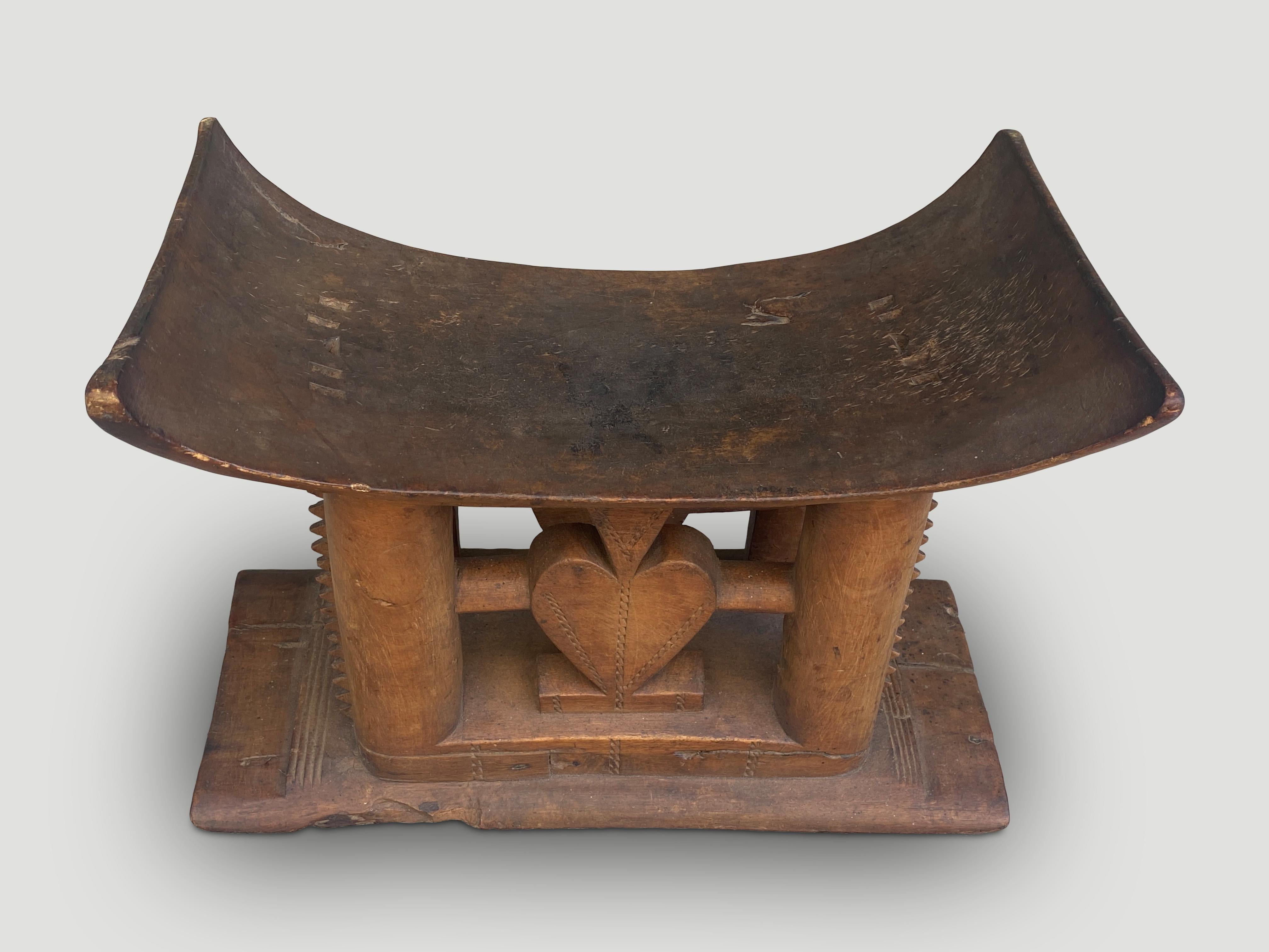 Beautiful carved heart on this Ashanti stool hand carved from a single piece of wood. These were originally given as gifts upon marriage and passed from father to son with different designs and meanings. Circa early 20th Century. We only source the