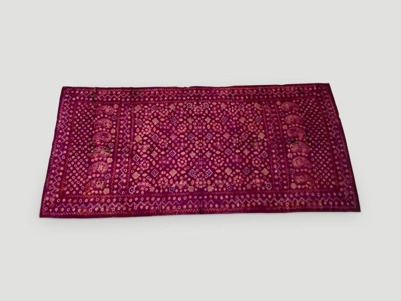 Stunning contrasting colors on this beautiful fine silk, tie dye ceremonial shoulder cloth from Palembang, Sumatra. Early 20 century.

This beautiful shawl can be worn or used as a wall hanging framed. We only source the best. 

Andrianna