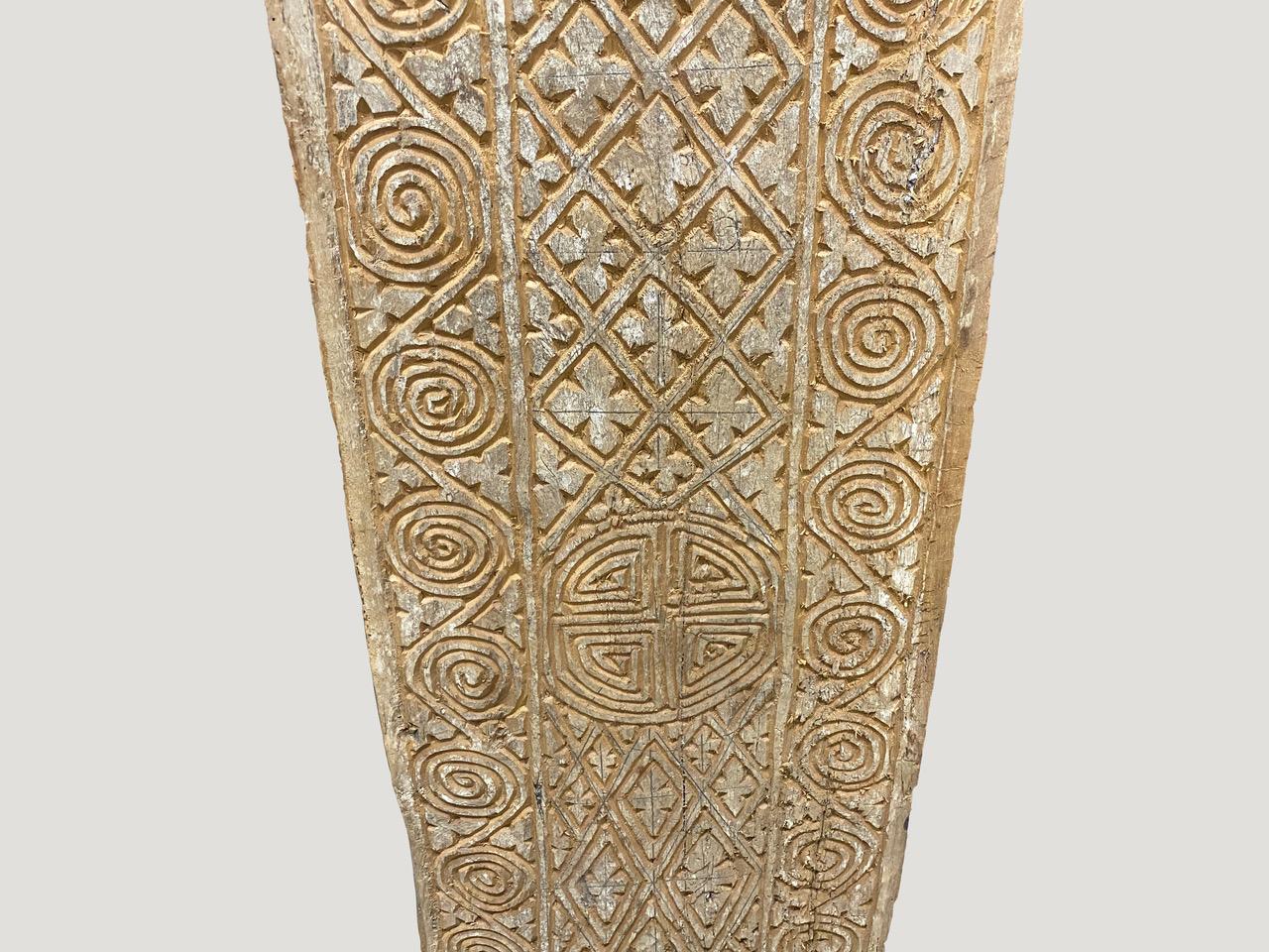 Ancient hand carved architectural panel from Toraja. The carving symbolizes both the protection of the home and fertility. Originally used as an exterior panel.

This panel was sourced in the spirit of wabi sabi, a Japanese philosophy that beauty
