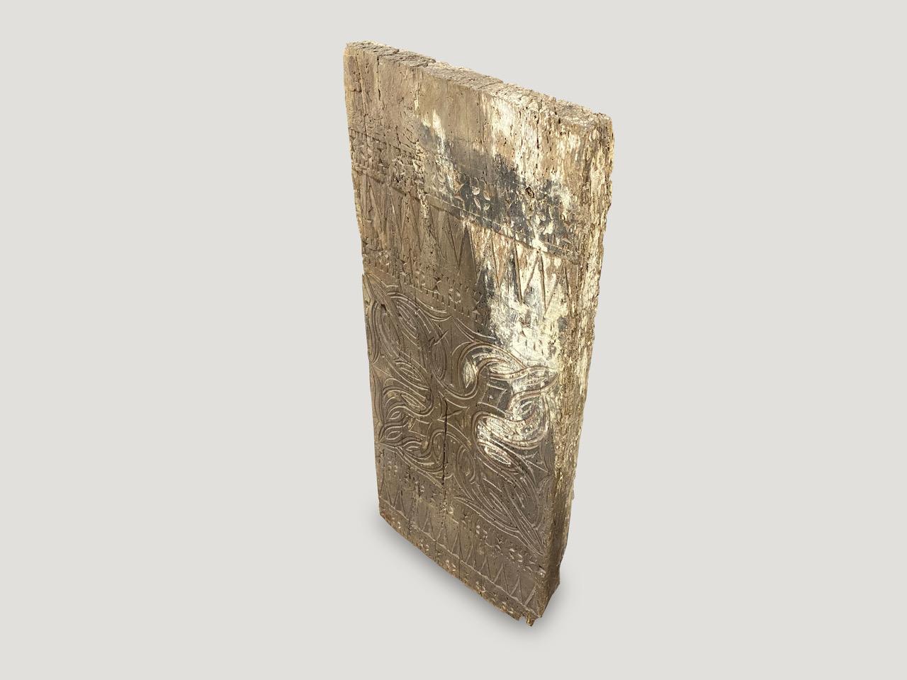 Ancient hand carved architectural panel from Toraja. This carving symbolizes both the protection of the home and courage. Originally used as an exterior panel. Beautiful art piece.

This hand carved panel was sourced in the spirit of wabi-sabi, a