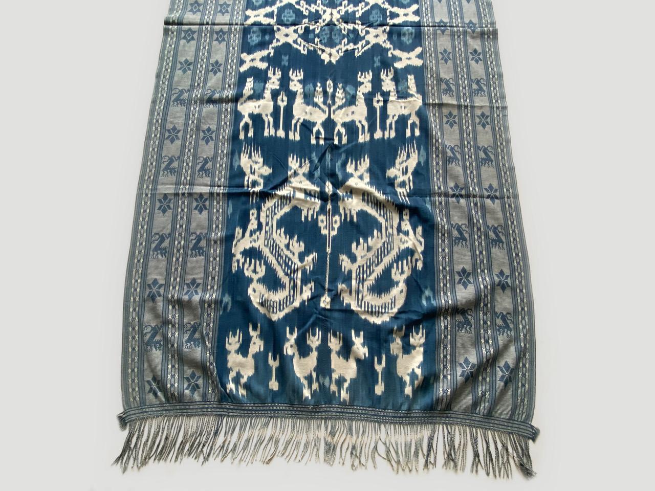 Beautiful antique indigo Ikat textile, from the island of Sumba. The stripes and stars seem modern, yet mixed with the traditional motif panel with mythical characters and sea horses, work so well together. On the opposite side the weave is reversed