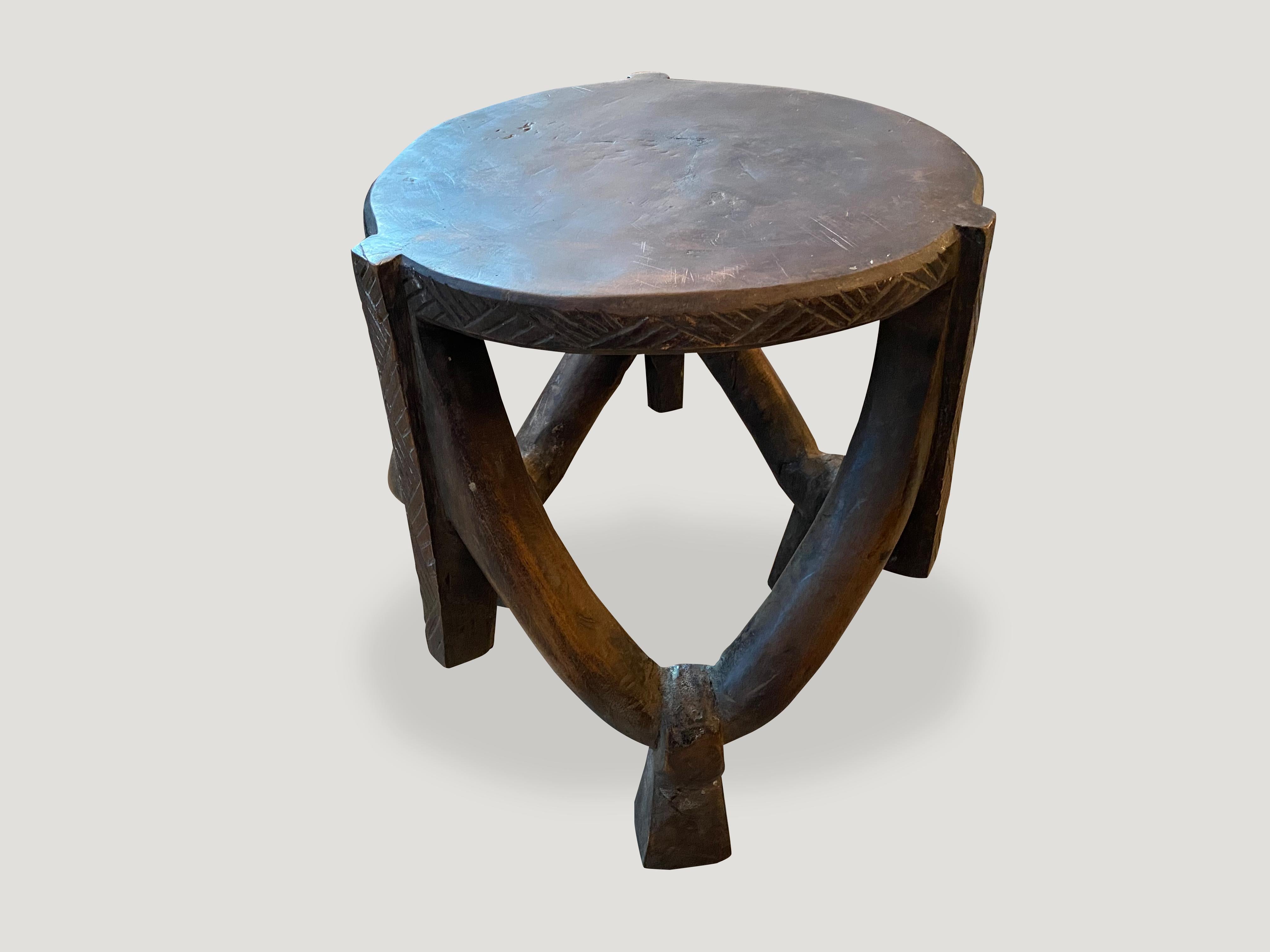 Impressive antique African mahogany side table or stool, hand carved from a single block of mahogany wood. Great for placing a book or perhaps towels in a bathroom, magazines etc. A beautiful, versatile item that is both sculptural and usable.