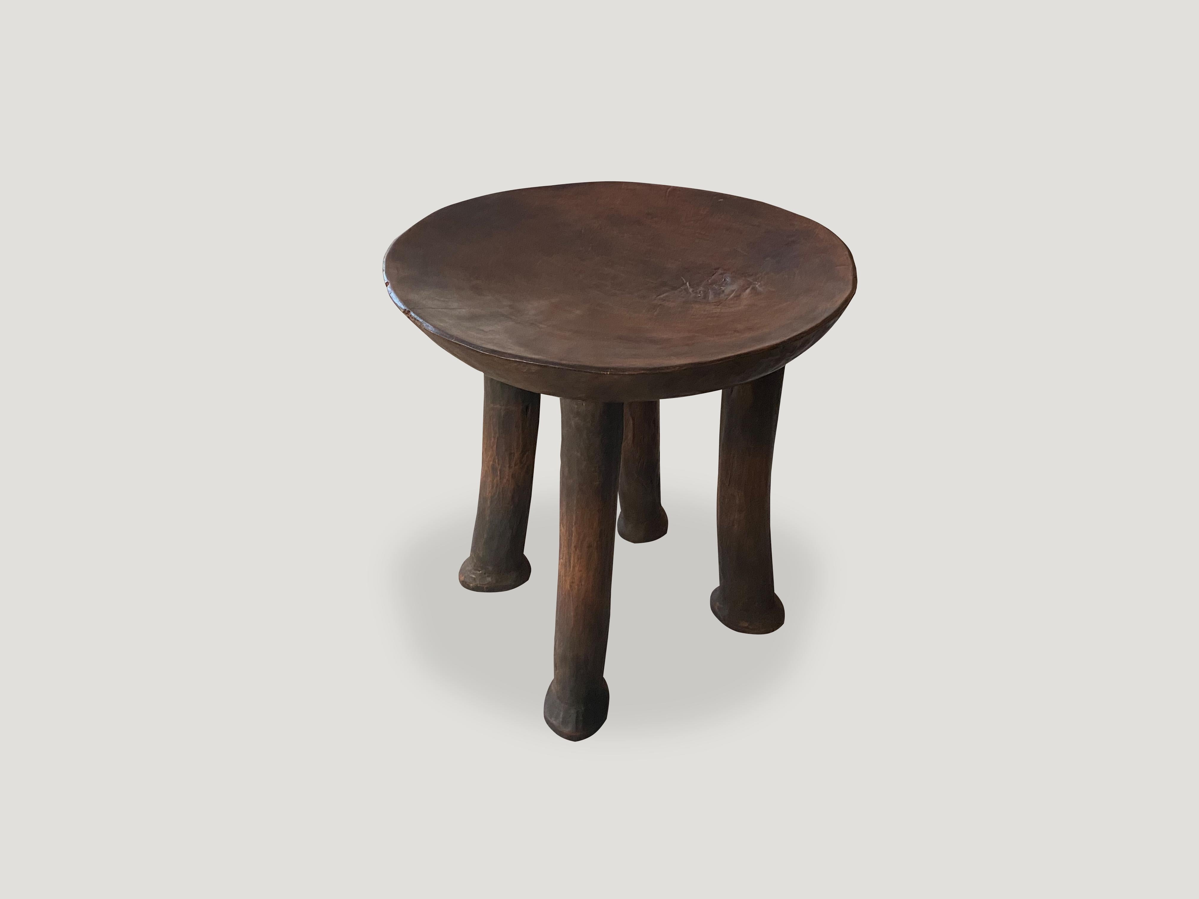 Sculptural African mahogany stool or side table with a beautiful half drum hand carved top. Great for placing a book or perhaps towels in a bathroom, magazines etc.

This stool or side table was sourced in the spirit of wabi-sabi, a Japanese