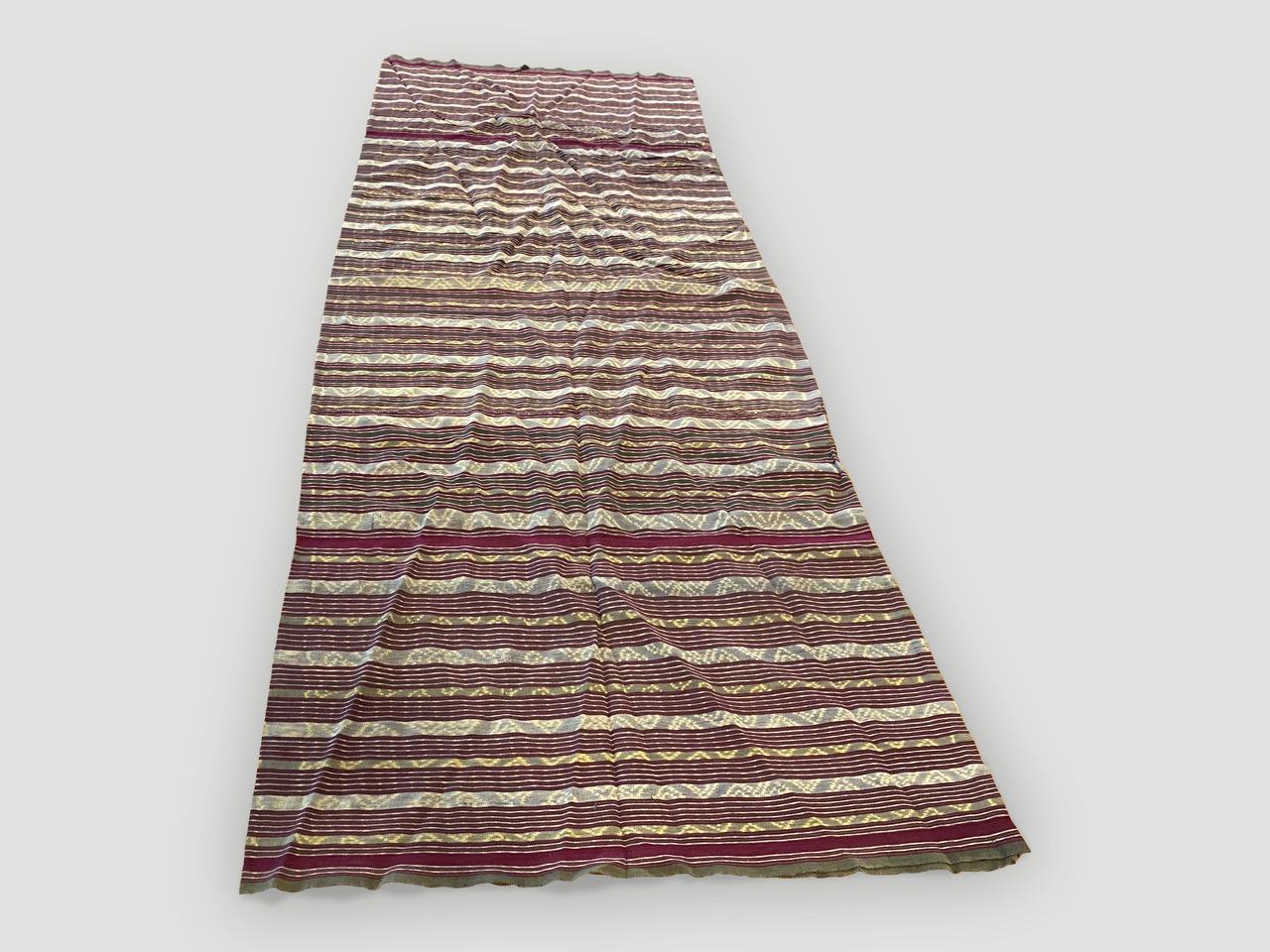 Beautiful antique sarong from Sumatra. There are so many uses for this soft cotton handwoven textile. This sarong is sewn into a circle to step into and roll around the waist to be worn. Opened the size is 69