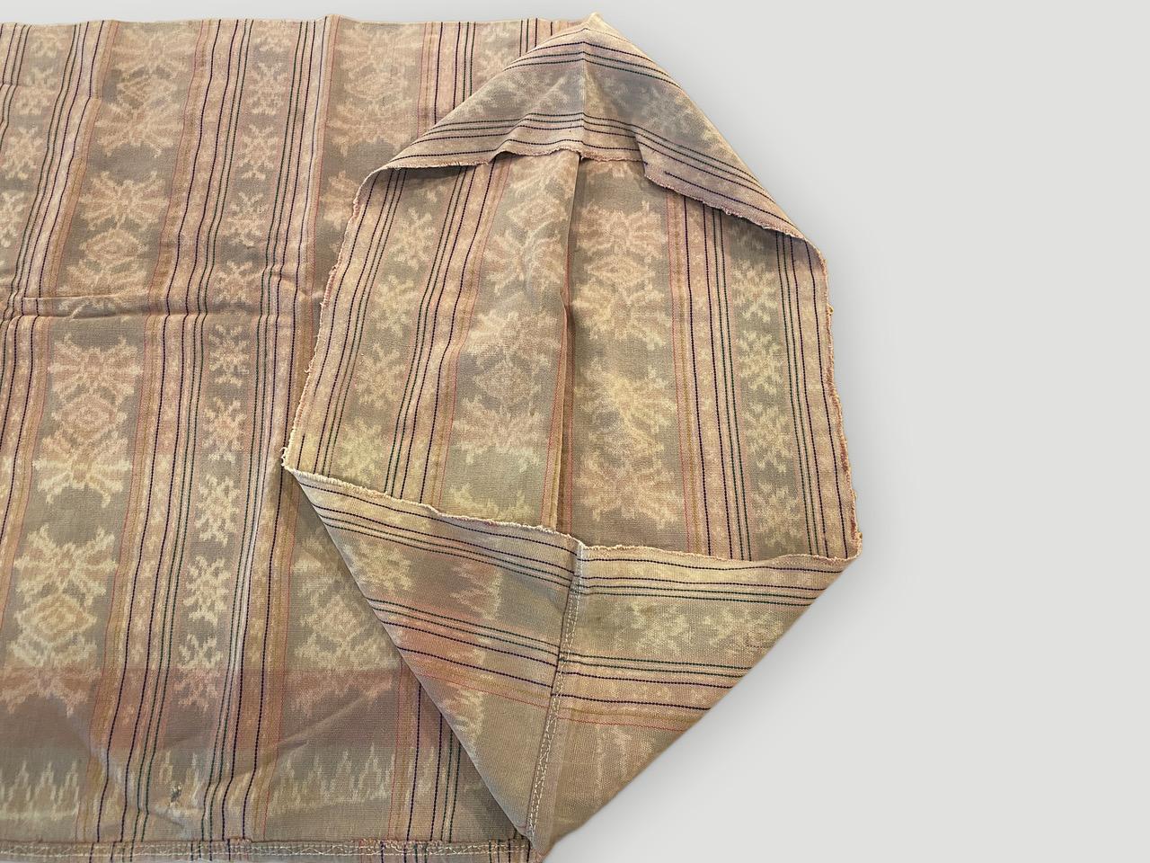 Beautiful antique sarong from Sumatra. There are so many uses for this soft dusty pink cotton handwoven textile. This sarong is sewn into a circle to step into and roll around the waist to be worn. Opened the size is 64” x 50