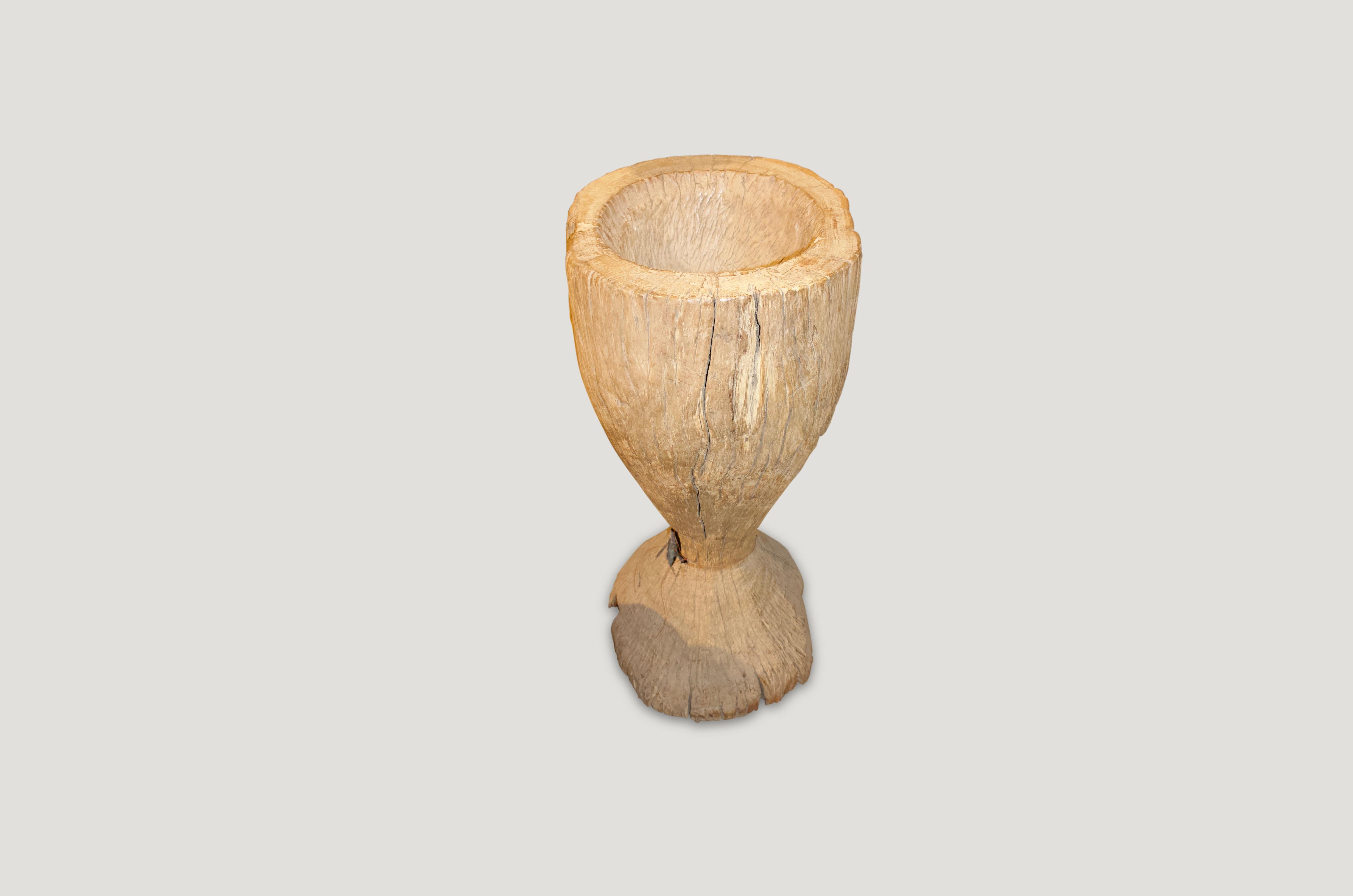 Antique rice pounder carved from a single teak root. Beautiful as a sculpture, holding towels or great as a champagne holder for parties. Also as a table base with a glass top.

This rice pounder was sourced in the spirit of wabi-sabi, a Japanese