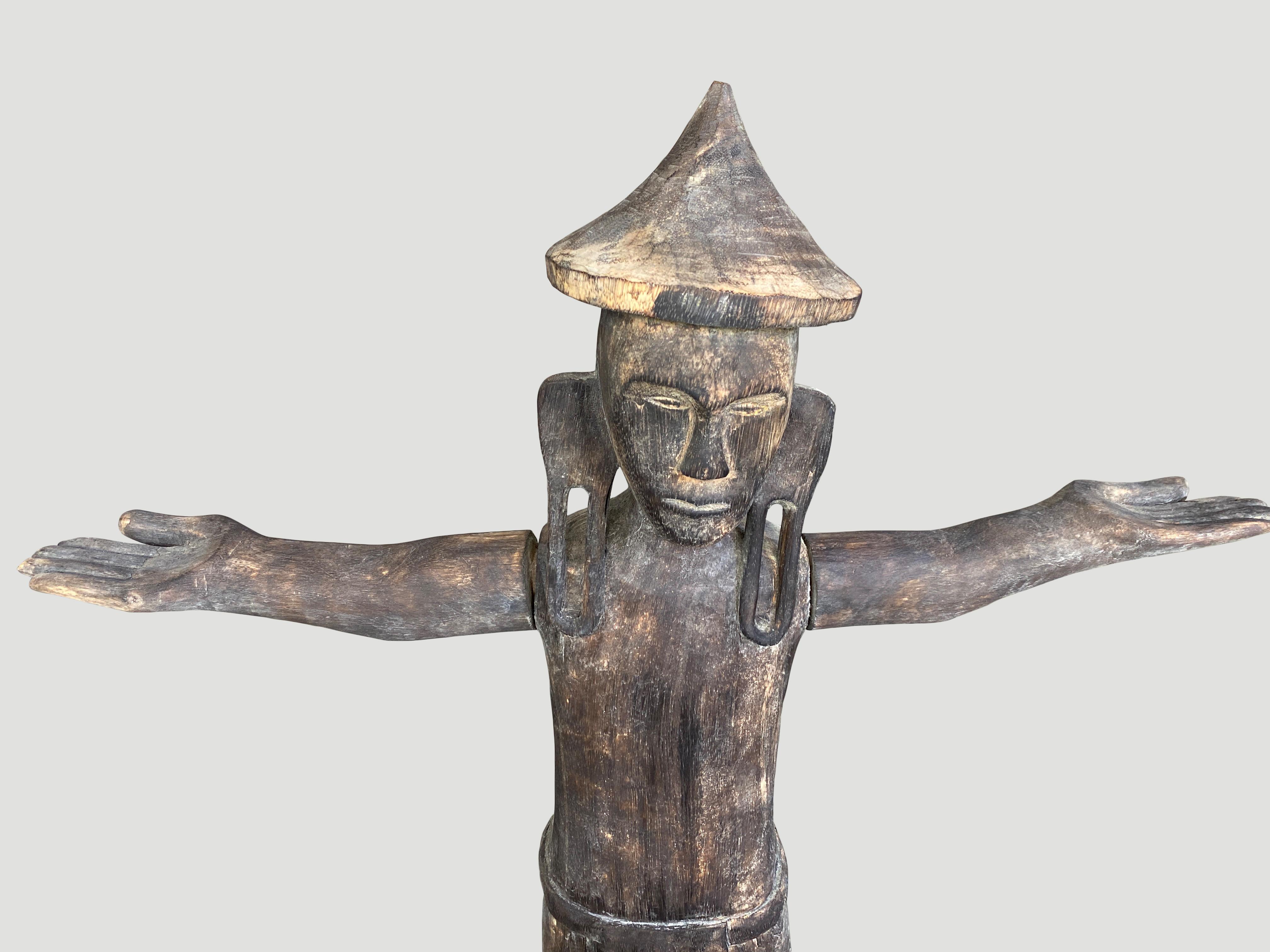 Antique male ‘police' statue hand carved from a single wood log from West Borneo, with arms that are pegged in. Originally used to protect the home from evil spirits and placed into the ground in front of the house as a guardian. 

This statue was