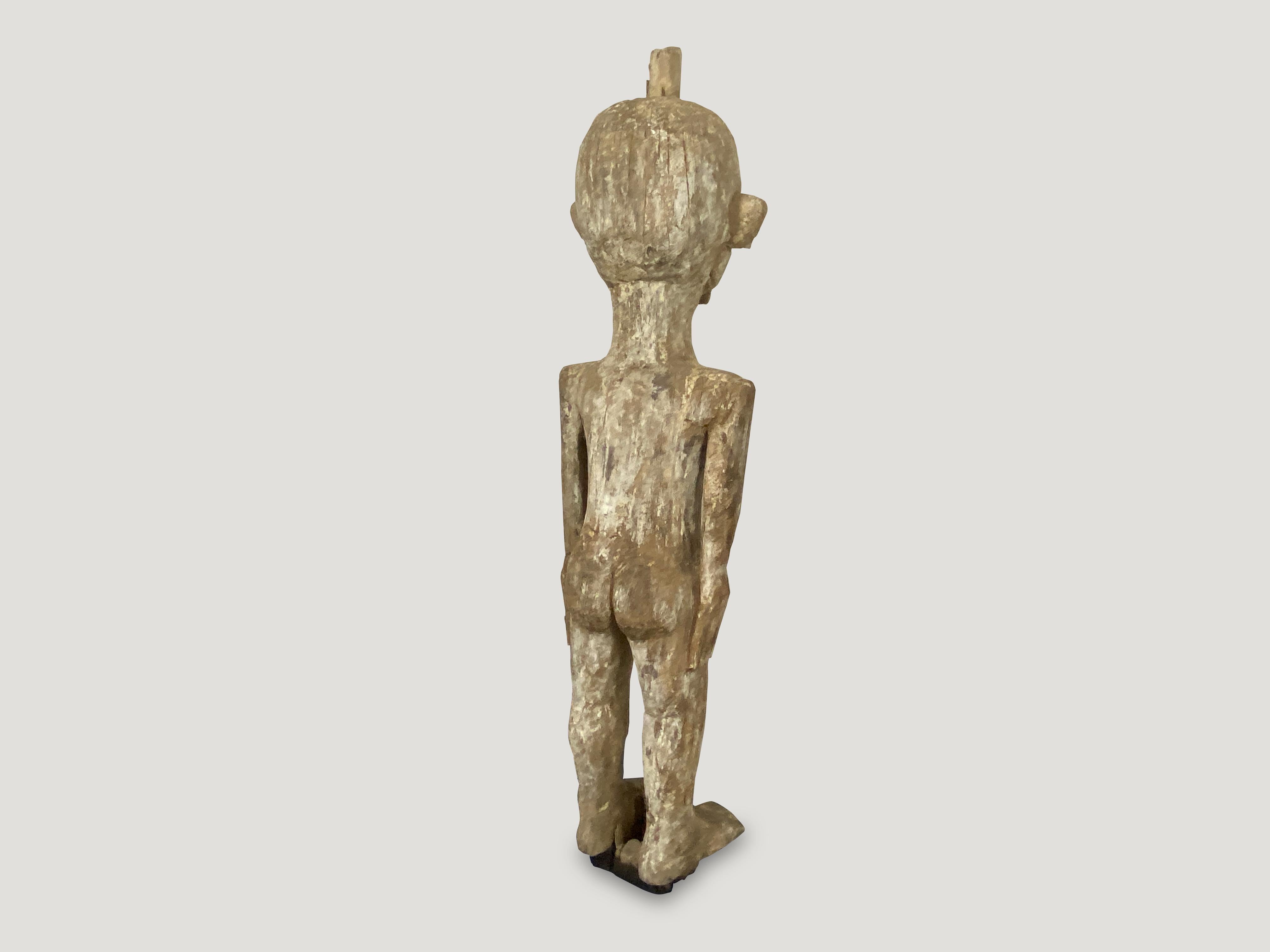 Antique hand carved statue of a primitive man from Sumatra. Originally used to protect the home. The wooden block under the feet were placed in the earth.

This statue was sourced in the spirit of wabi-sabi, a Japanese philosophy that beauty can