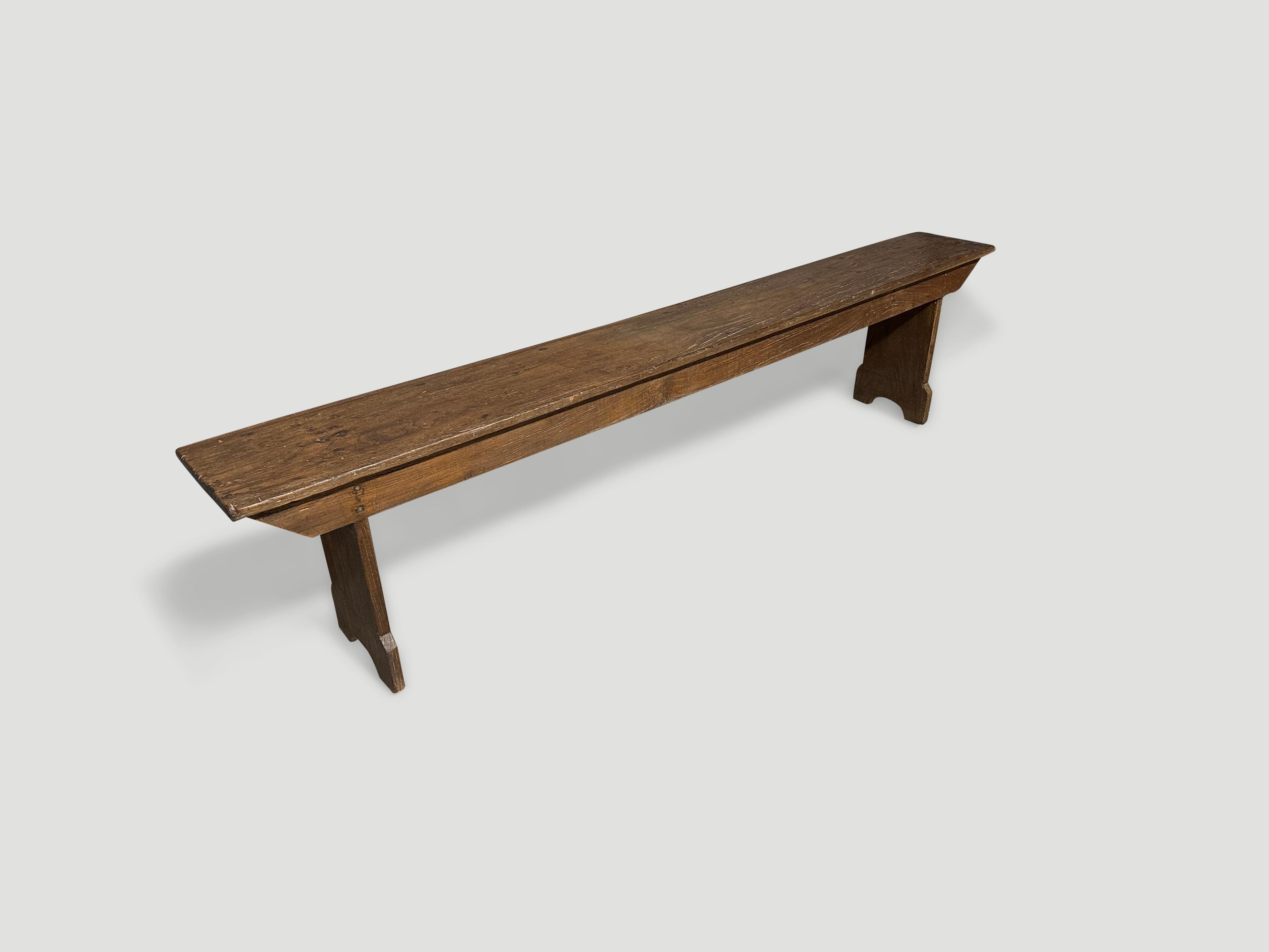 Antique bench hand made from a single top panel of teak wood with lovely patina. Finished in a natural oil revealing the beautiful wood grain. Circa 1950.

This bench was hand made in the spirit of Wabi-Sabi, a Japanese philosophy that beauty can be