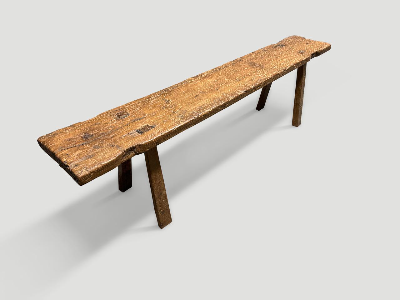 Antique bench hand made from a single panel of teak wood with lovely patina. Circa 1950.

This bench was hand made in the spirit of Wabi-Sabi, a Japanese philosophy that beauty can be found in imperfection and impermanence. It is a beauty of things