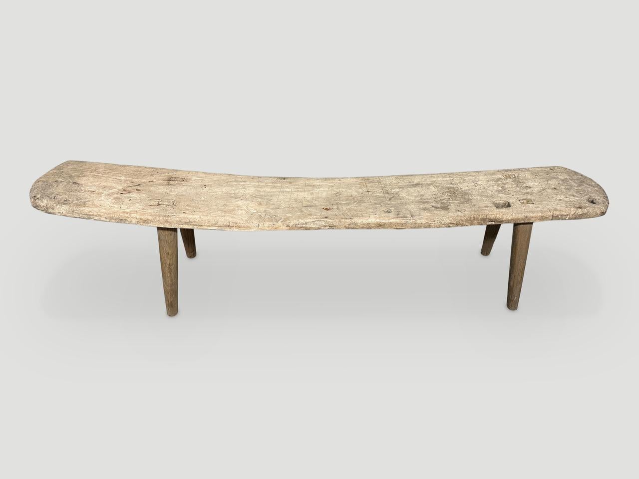 Antique Wabi Sabi teak bench or chaise celebrating the cracks and crevices and all the other marks that time and loving use have left behind. We added smooth teak minimalist legs in contrast to the top. The back rest graduates to 19
