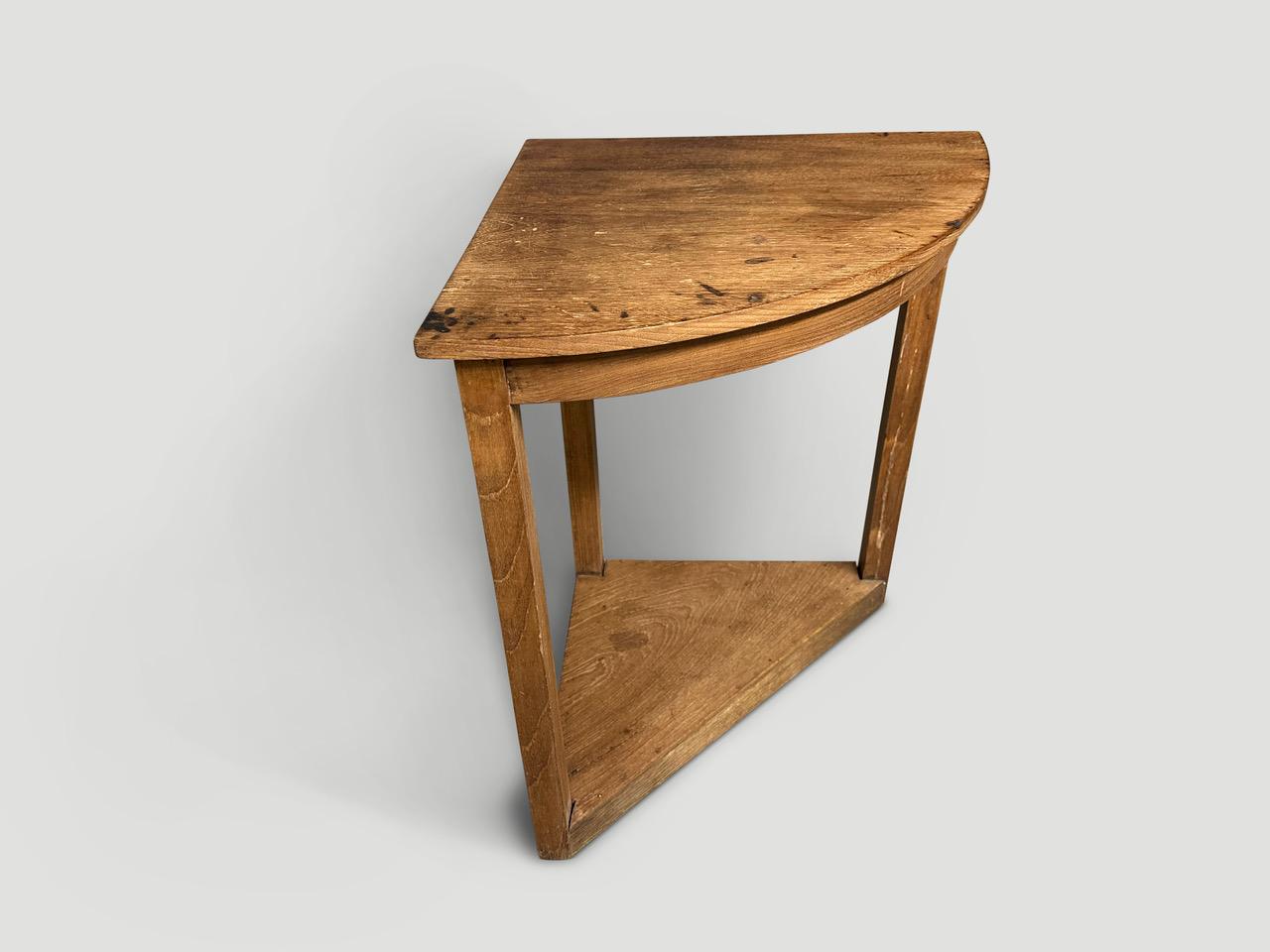 Teak wood Wabi Sabi antique corner table. Celebrating all the marks that time and loving use have left behind. Circa 1950. Full dimensions; Each straight side is 19.5” x curved side 27.5” wide. 

This side table was hand made in the spirit of