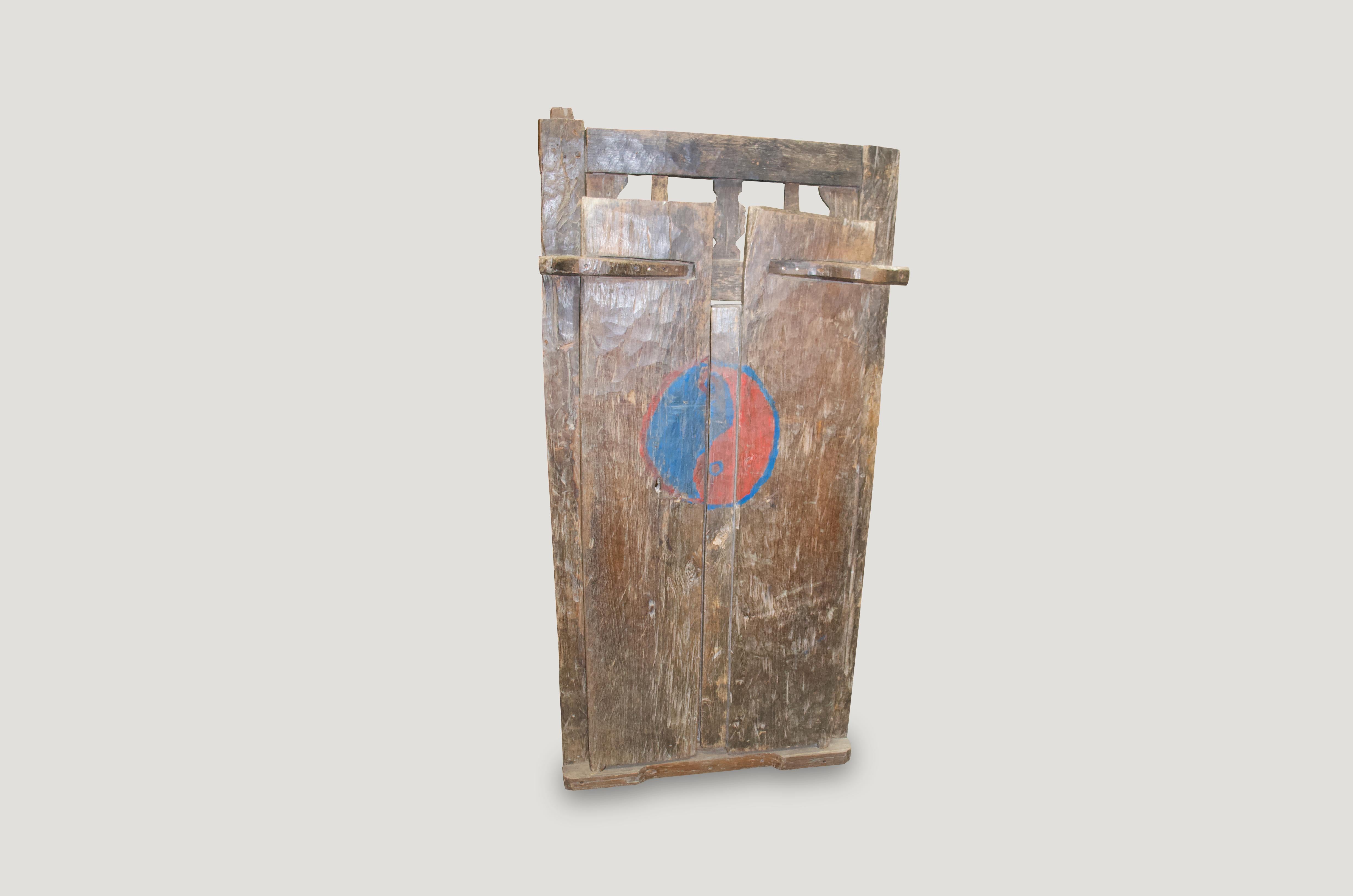 Beautiful patina on this door frame and teak wood doors with original wooden hardware. All hand-carved. Great to incorporate as an architectural element or simply hung on a wall as art.

These antique doors were sourced in the spirit of wabi-sabi, a