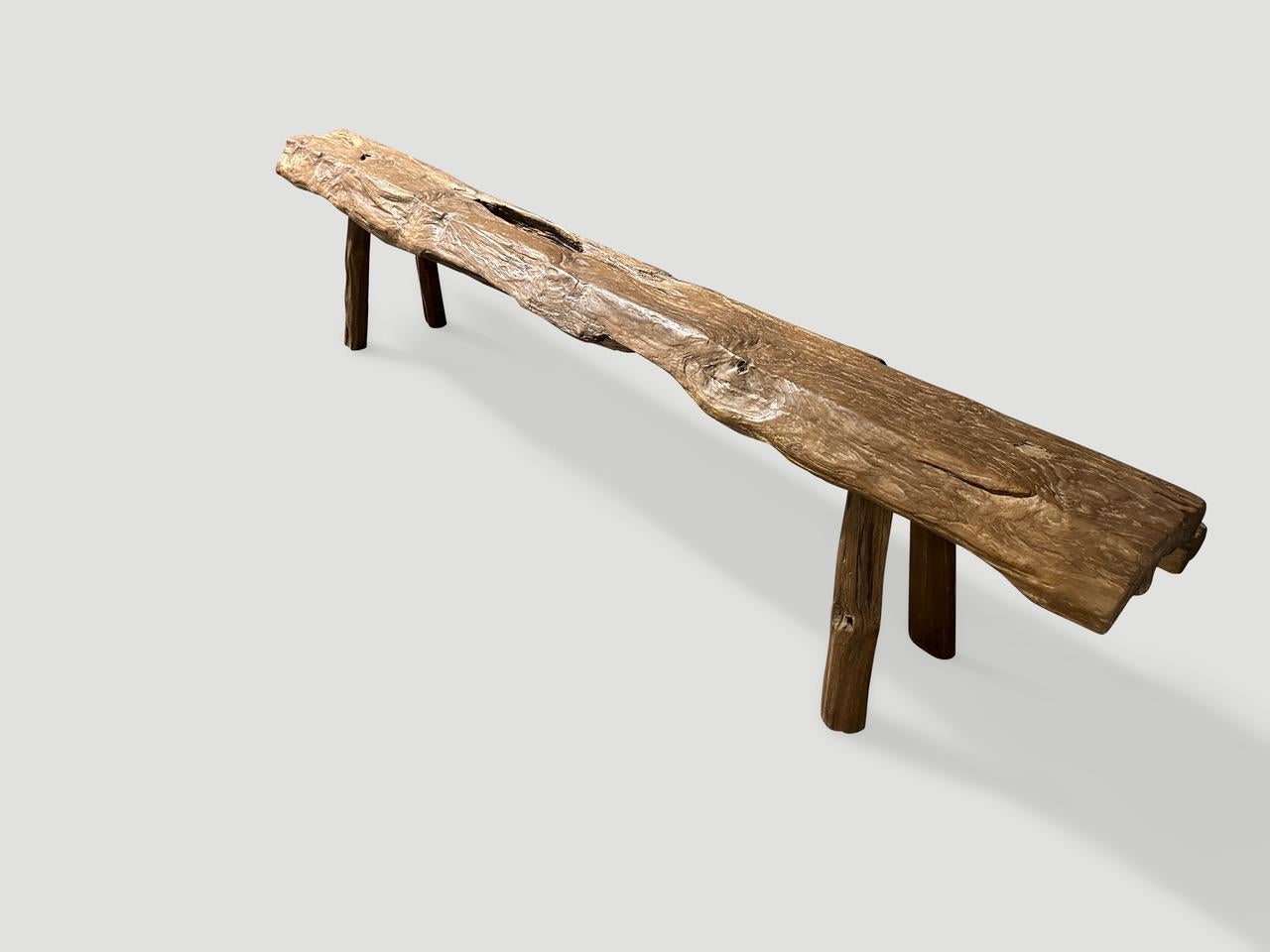 Impressive antique bench with beautiful character and patina hand made from a single four inch thick teak log. Circa 1950.

This bench was hand made in the spirit of Wabi-Sabi, a Japanese philosophy that beauty can be found in imperfection and
