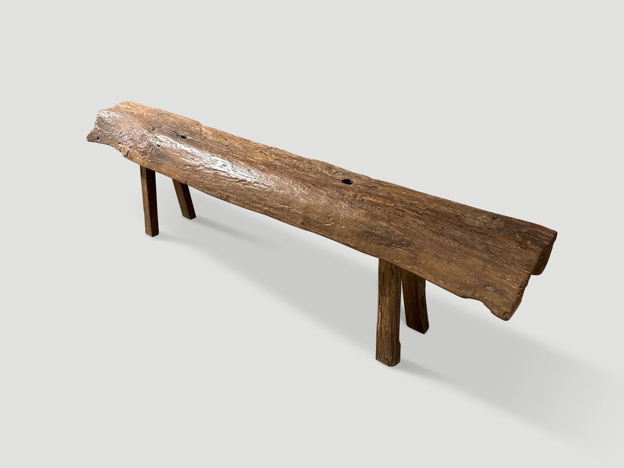 Impressive antique bench with beautiful character and patina is hand made from a single thick teak log. Circa 1950.

This bench was hand made in the spirit of Wabi-Sabi, a Japanese philosophy that beauty can be found in imperfection and