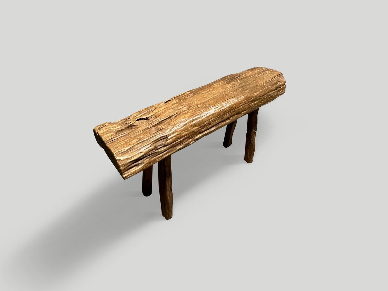Antique bench with beautiful character hand made from a three inch thick teak log. Circa 1950. 

This bench was hand made in the spirit of Wabi-Sabi, a Japanese philosophy that beauty can be found in imperfection and impermanence. It is a beauty of