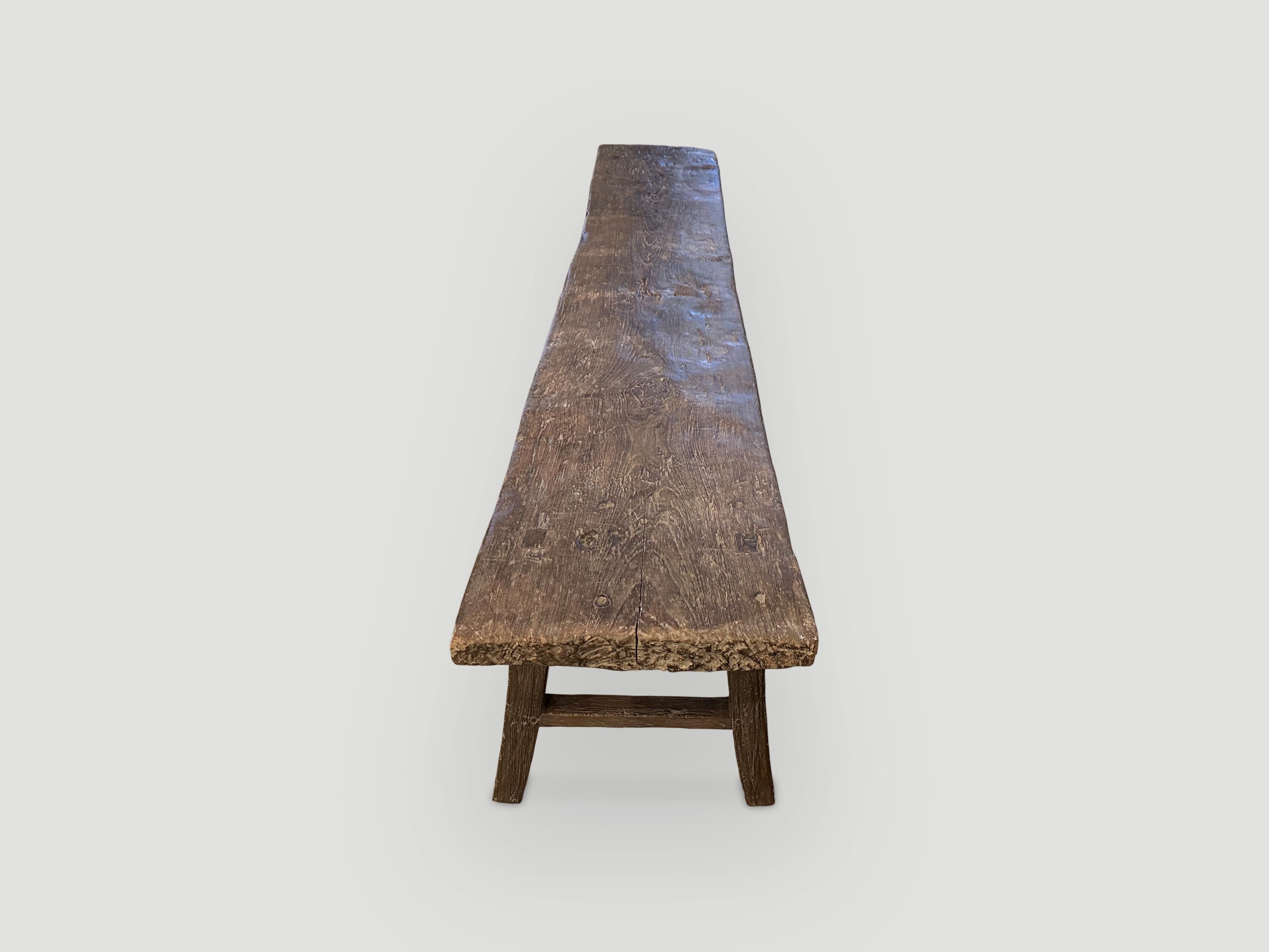 Antique beautiful single teak slab with lovely patina. We added legs to this aged panel. 

This bench was hand made in the spirit of Wabi-Sabi, a Japanese philosophy that beauty can be found in imperfection and impermanence. It is a beauty of