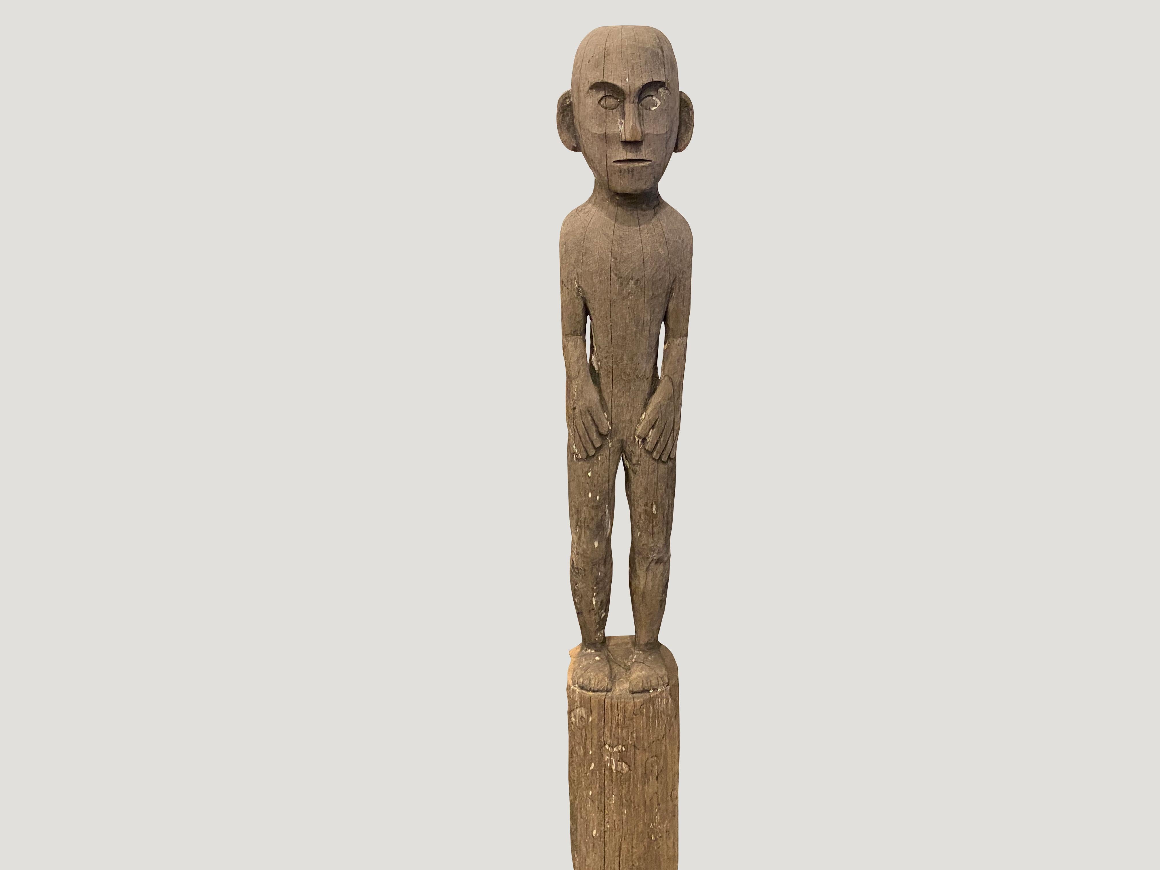 Antique male statue hand carved from a single teak wood log from West Borneo. Originally used to protect the home from evil spirits and placed into the ground in front of the house as a guardian. We have added a modern metal black base.

This