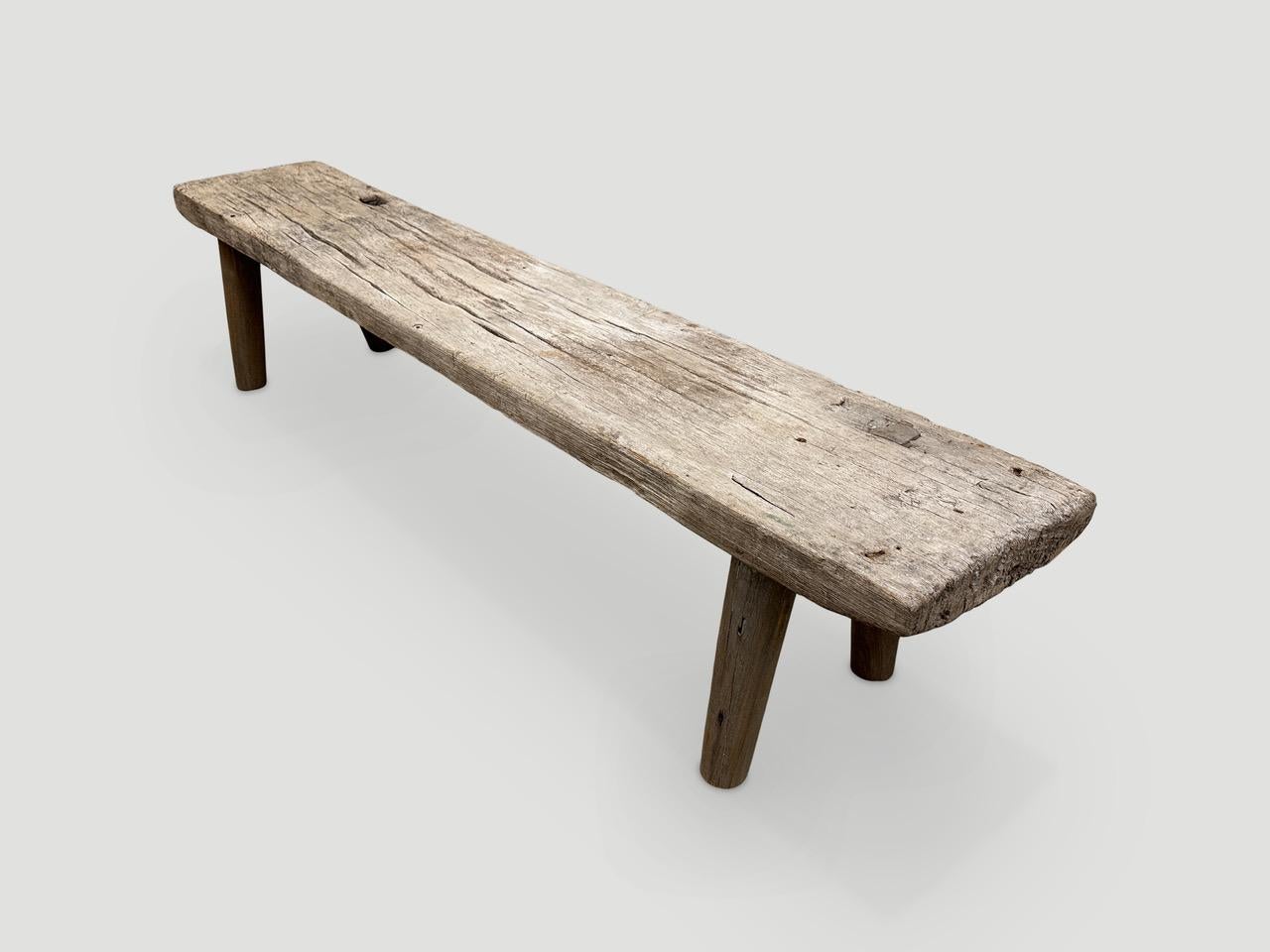 Antique Wabi Sabi teak bench celebrating the cracks and crevices and all the other marks that time and loving use have left behind. We added smooth teak minimalist legs to this beautiful thick aged panel. It’s all in the details.

This bench was