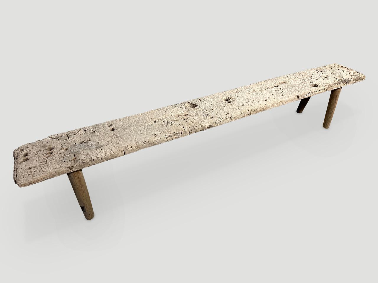 Antique Wabi Sabi teak bench celebrating the cracks and crevices and all the other marks that time and loving use have left behind. We added smooth teak minimalist legs to this thick slab plus a light bleach revealing the beautiful wood