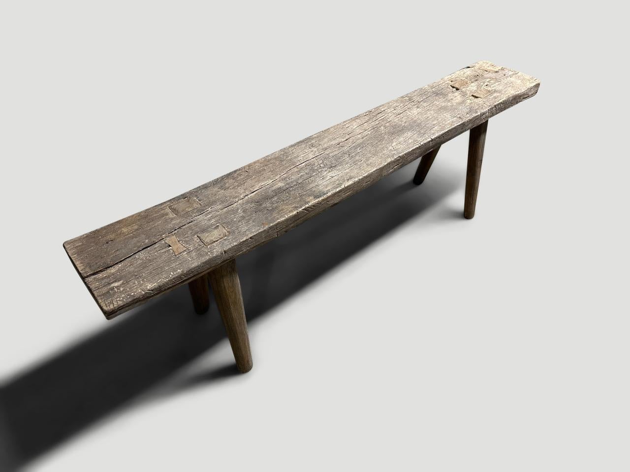 Antique Wabi Sabi teak bench celebrating the cracks and crevices and all the other marks that time and loving use have left behind. We added smooth teak minimalist legs to this beautiful aged panel and butterflies inlaid into the wood. It’s all in