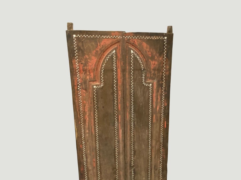Antique temple door in teak wood with the original pretty coral color. We added the shell inlay by hand. Great as a headboard, coffee table or simply as a piece of art. We currently have a large collection of temple doors available. All unique with