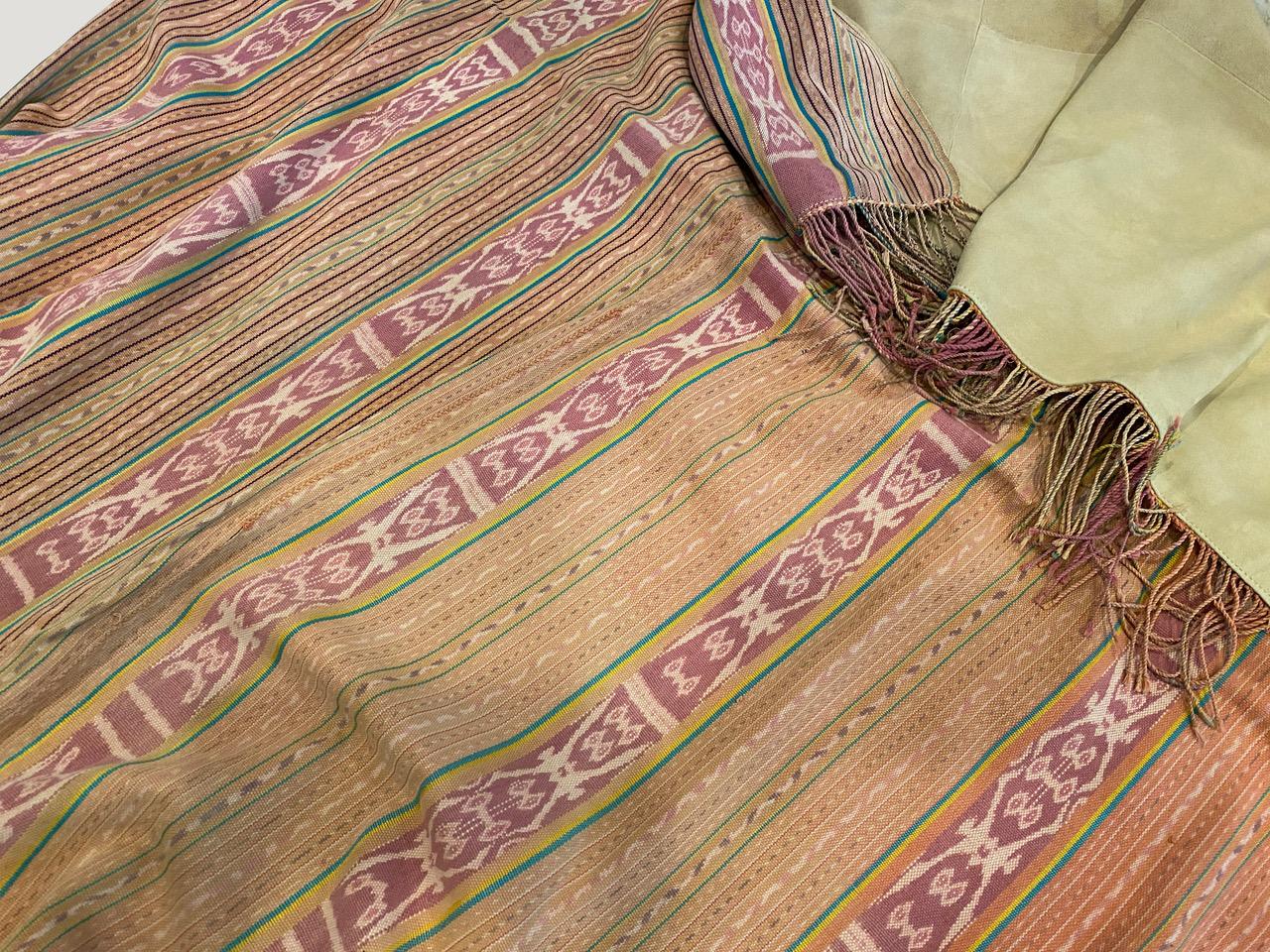 Beautiful antique Ikat textile from the island of Sumba, fully backed in a luxurious soft suede. The stripes seem modern yet mixed with the traditional motif panel, work so well together. Ikat is an ancient technique which is used to add patterns to