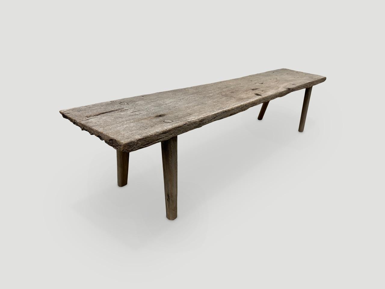 Antique Wabi Sabi bench with beautiful patina. A single aged teak panel celebrating the cracks and crevices and all the other marks that time and loving use have left behind. We added smooth teak wood minimalist legs. 

This bench was handmade in