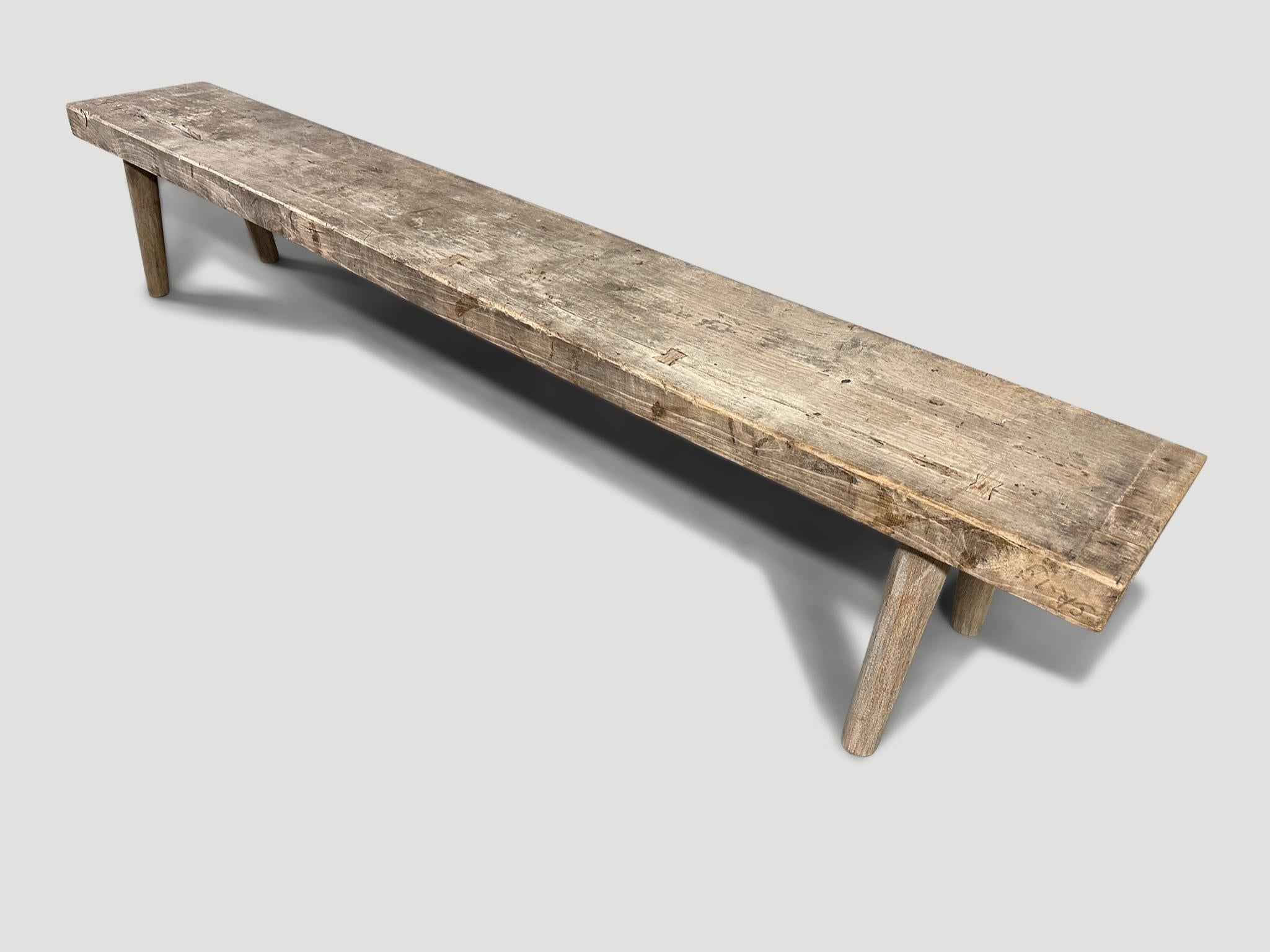 Antique Wabi Sabi bench with beautiful wood tones. A single wide aged 2.5” thick teak slab celebrating the cracks and crevices that time and loving use have left behind. We added smooth teak minimalist legs and butterflies inlaid into the top. It’s