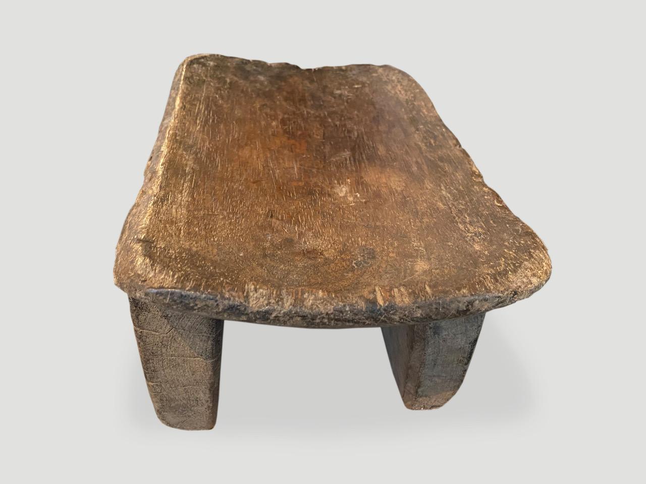 Lovely patina on this beautiful African stool hand carved from a single piece of wood. Great for placing a book or perhaps towels in a bathroom, magazines etc.

This stool was sourced in the spirit of wabi-sabi, a Japanese philosophy that beauty