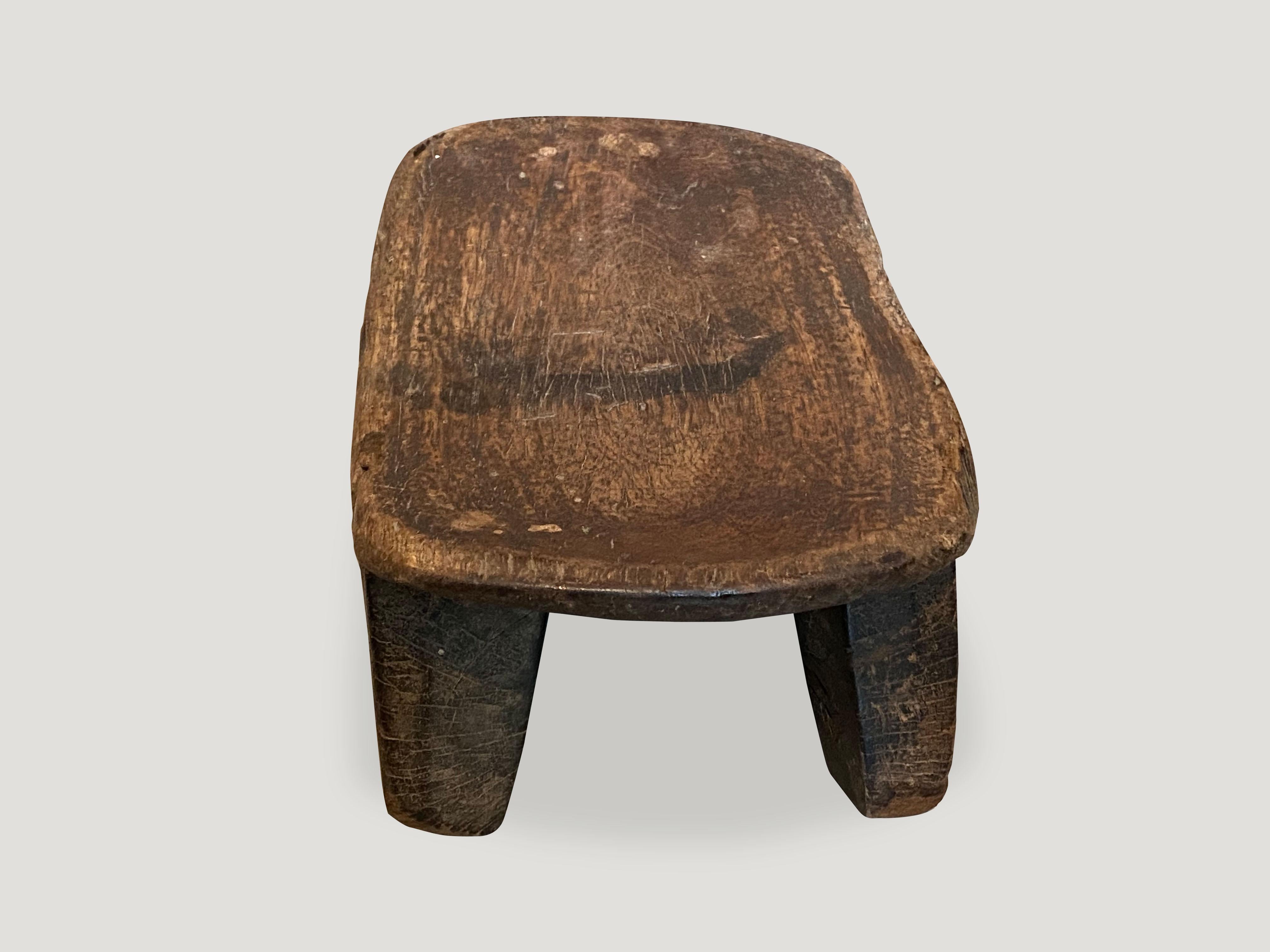 Lovely patina on this beautiful African stool hand carved from a single block of wood. Great for placing a book or perhaps towels in a bathroom, magazines etc.

This stool was sourced in the spirit of wabi-sabi, a Japanese philosophy that beauty