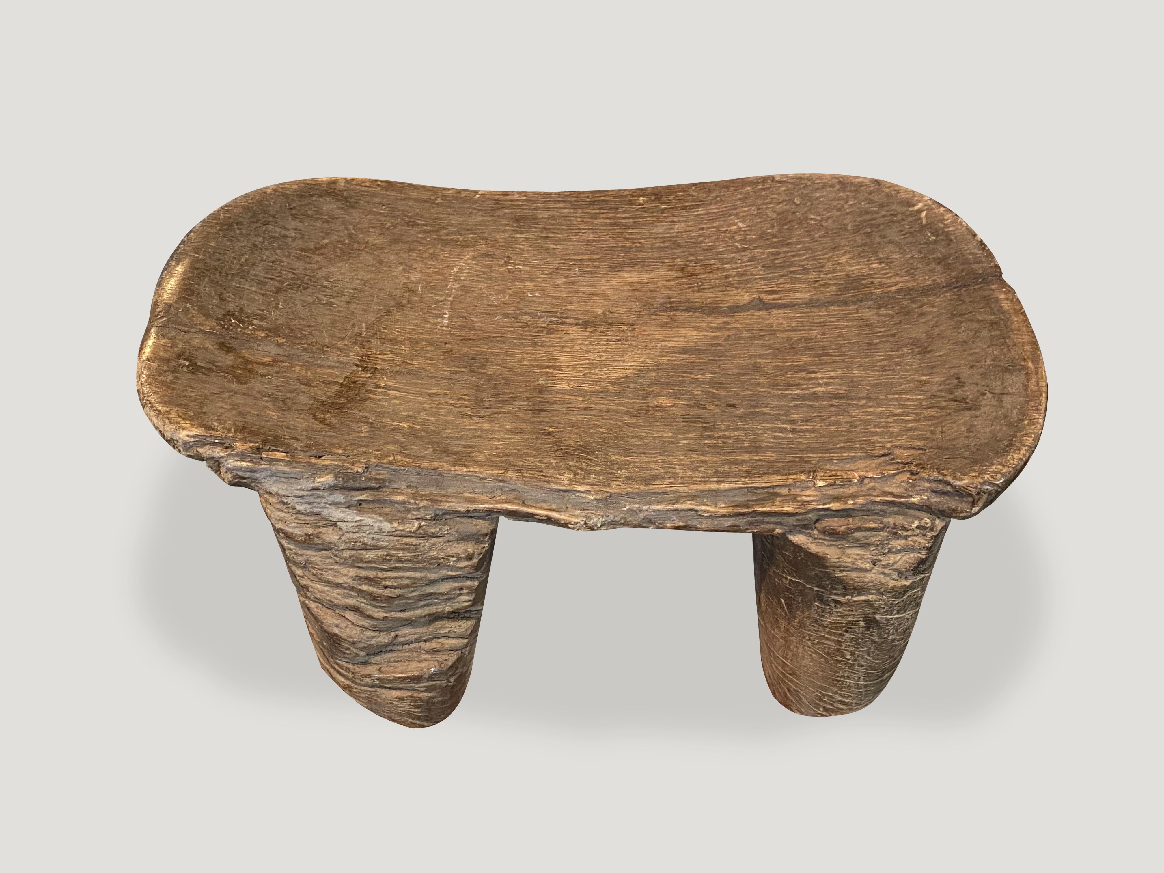 Beautiful African stool hand carved from a single block of wood. Lovely markings through out celebrating the cracks and crevices and all the other marks that time and loving use have left behind. This almost feels like a fossilized piece of art.