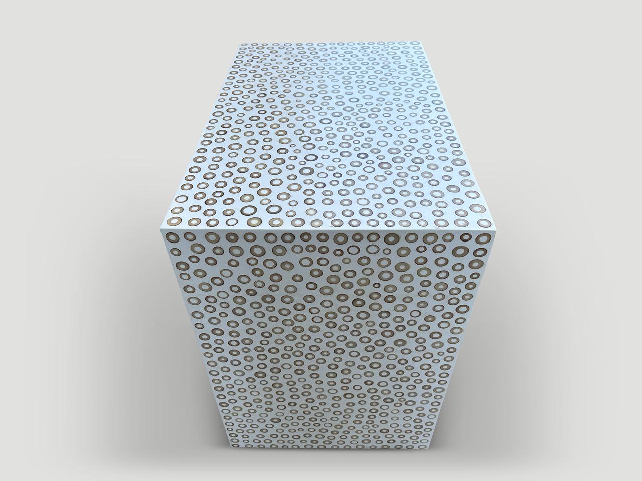 The unique bamboo inlay and resin design is a fusion of modern and natural elements. Each natural bamboo slice is carefully inlayed into the resin, which is stained white to create a sleek, modern aesthetic. Perfect as a console, entry table or