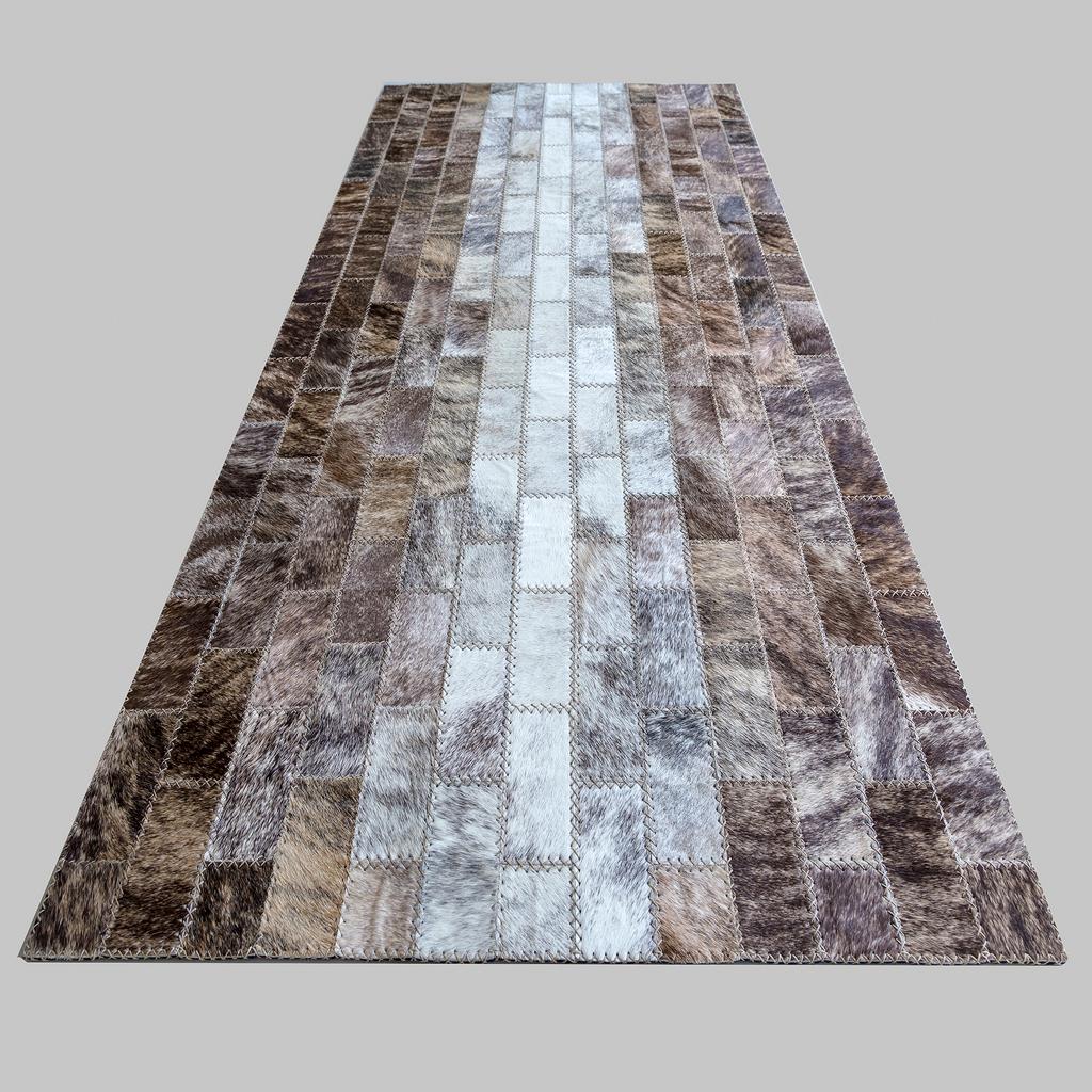 Bespoke, handmade area rugs, constructed using handcut cowhide tiles.

The cowhides are hand selected, top-of-the-line hair-on hide skins, stitched together with virtually unbreakable waxed-cotton thread with a polyester core. Sustainably sourced