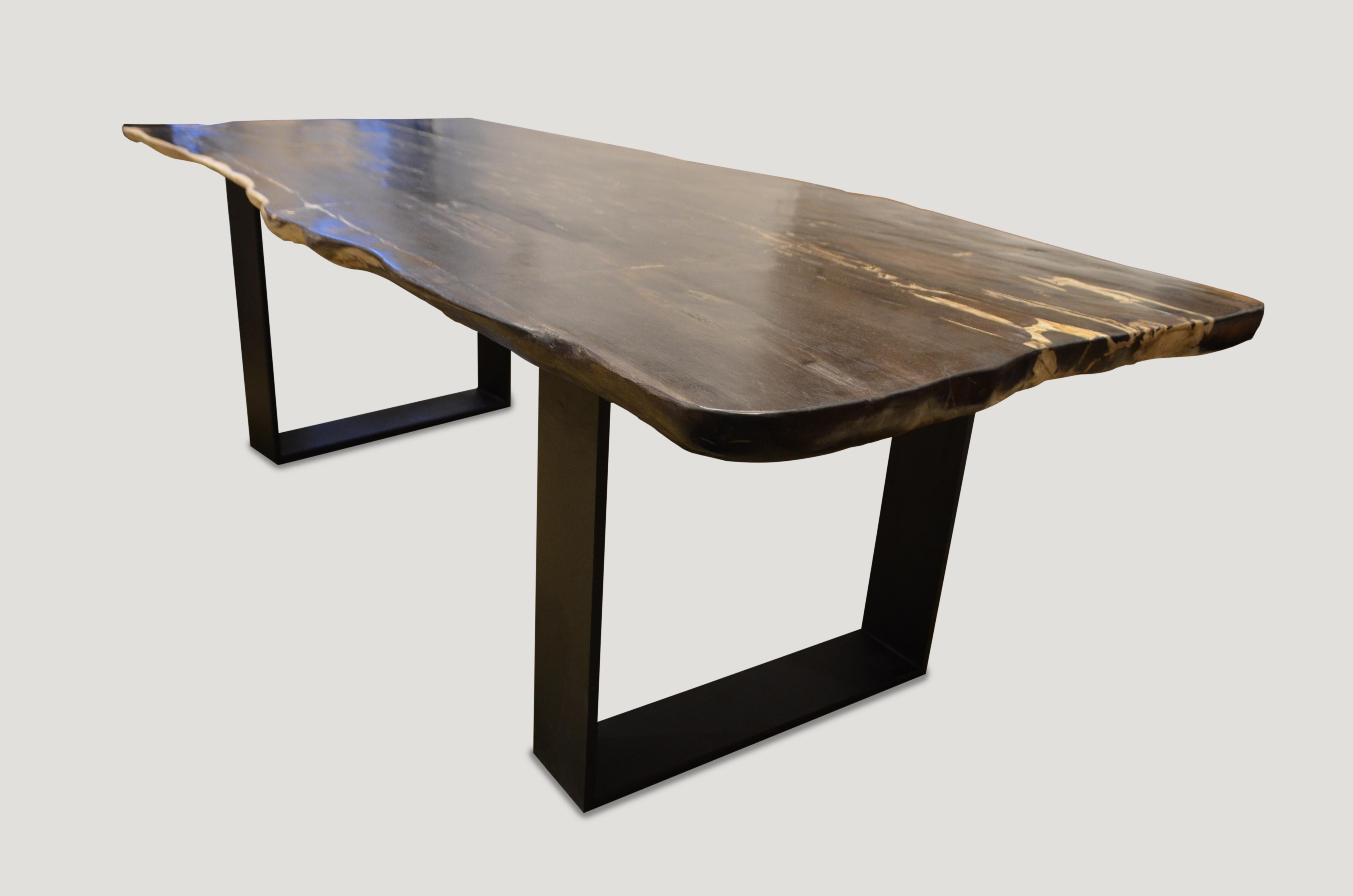 High quality petrified wood live edge dining table, coffee table or counter top. This two inch thick slab is shown with a black solid steel base which we can also switch out for two espresso stained wooden bases, coffee table height, if preferred.